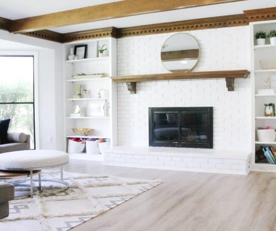 photo of living room with large white brick fireplace
