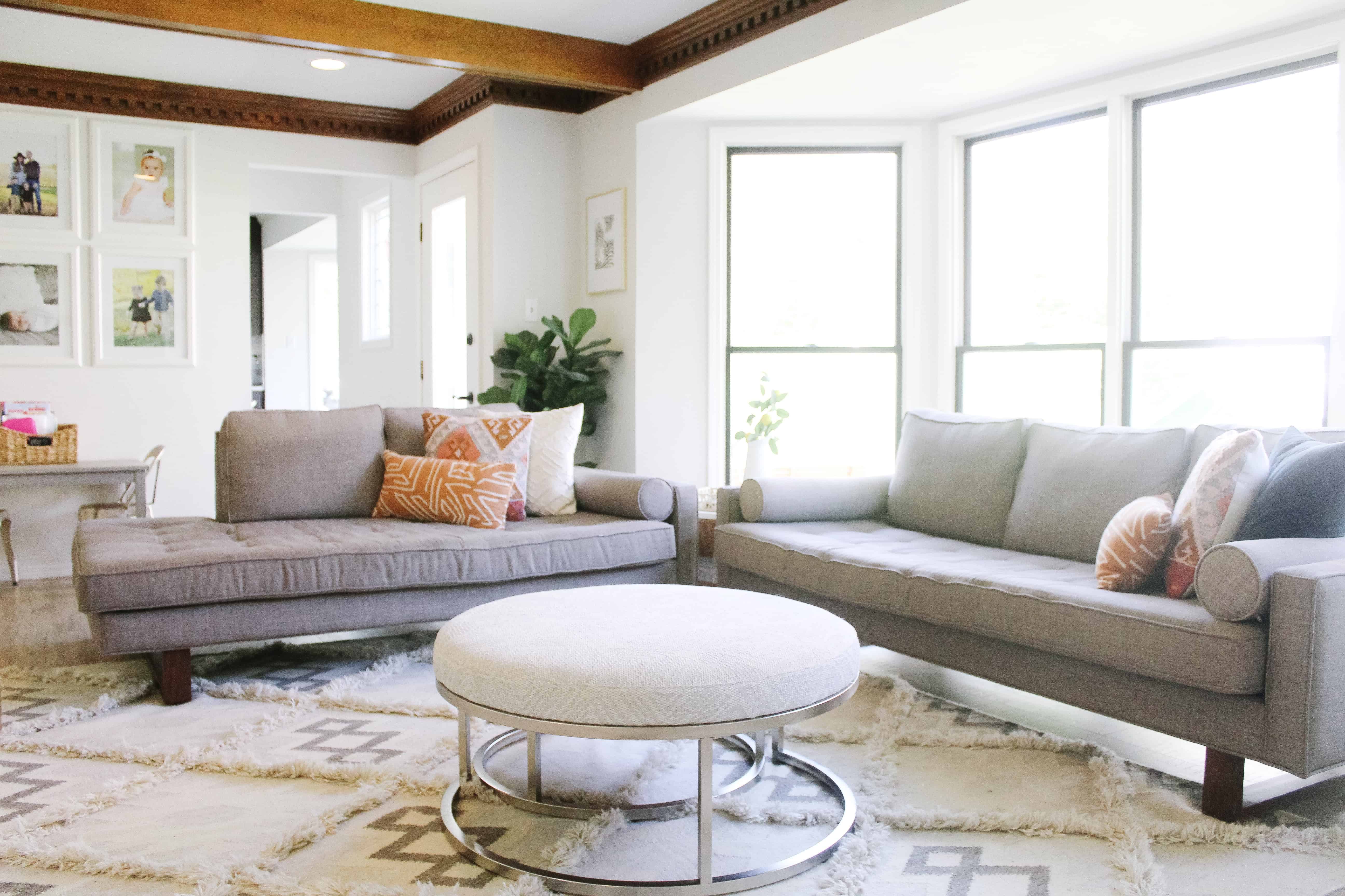 a view of a living room with midcentury modern grey couches