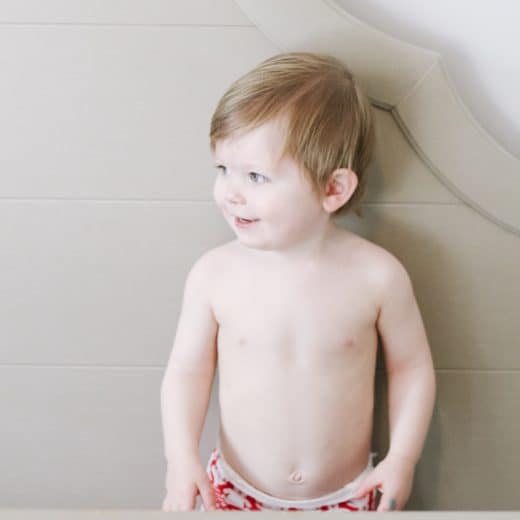 photo of toddler standing in bed
