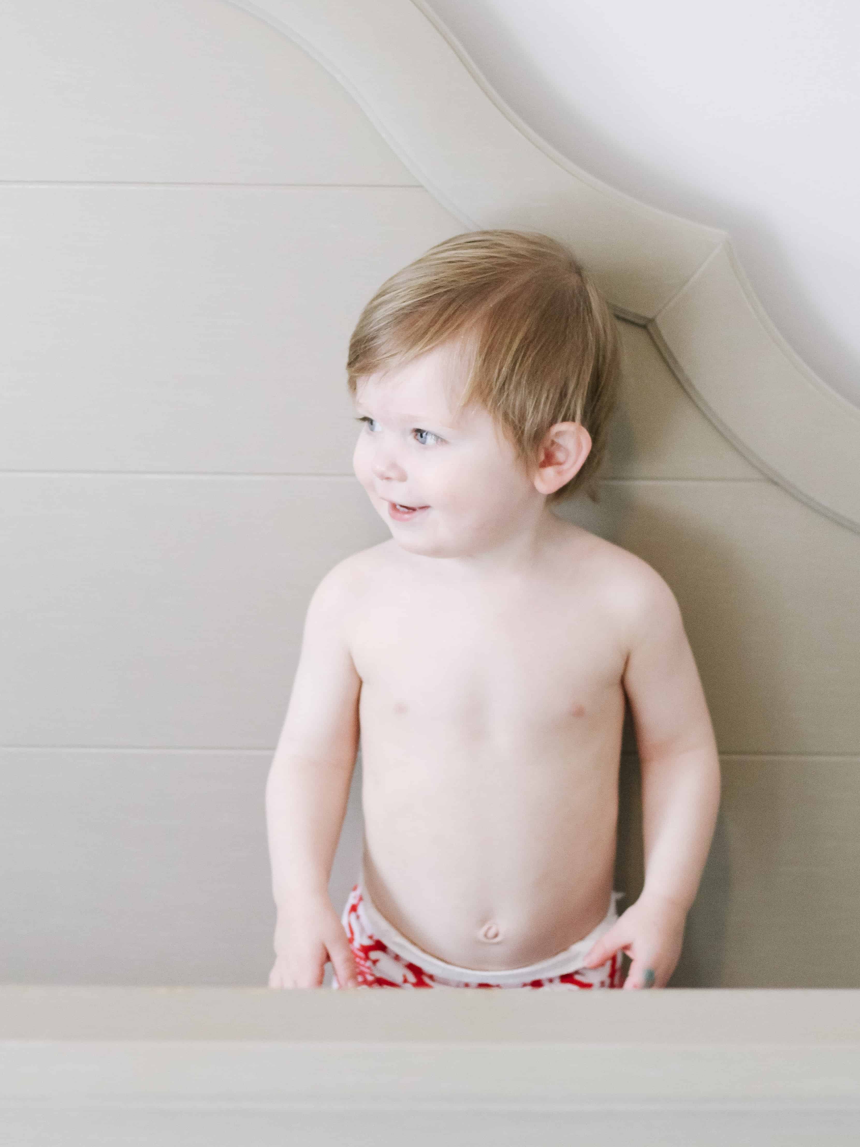 photo of toddler standing in bed