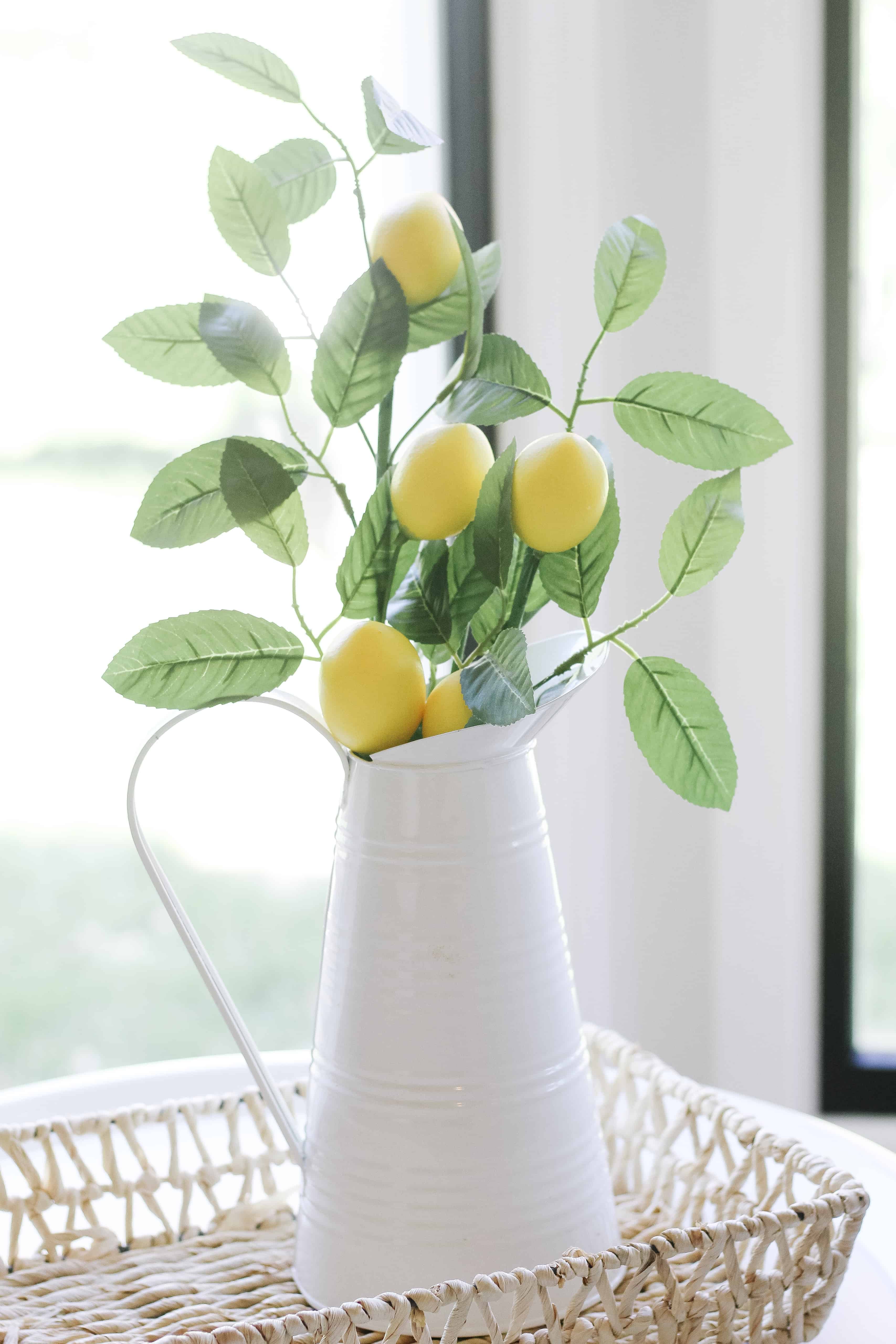 lemons and greenery in white metal vase