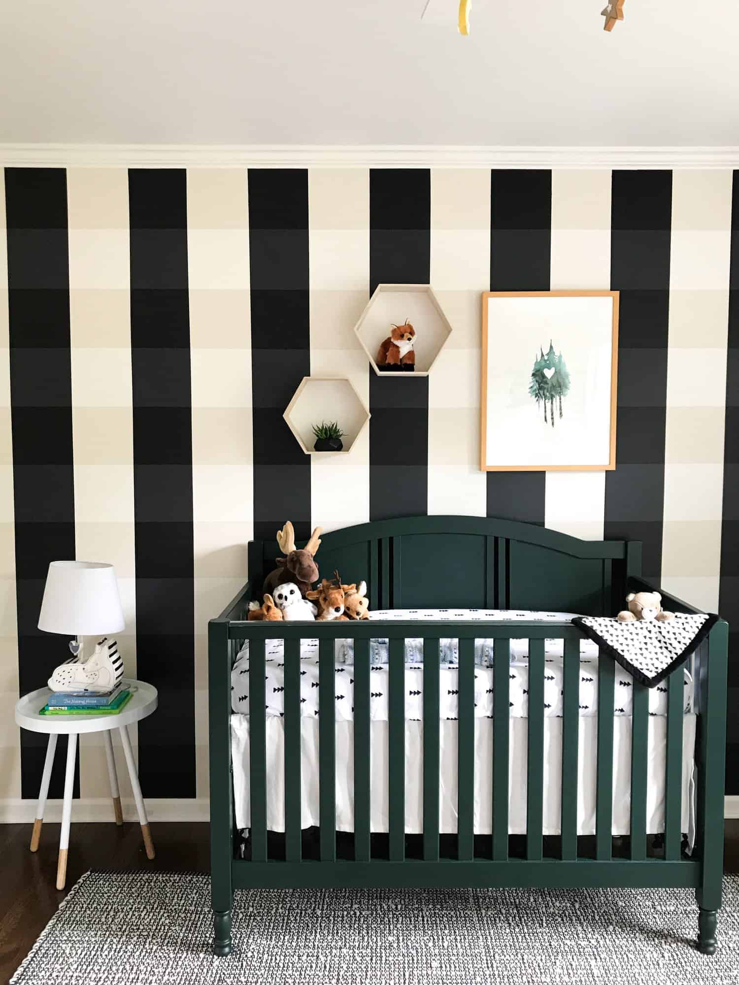 Black gingham wall in nursery behind black crib