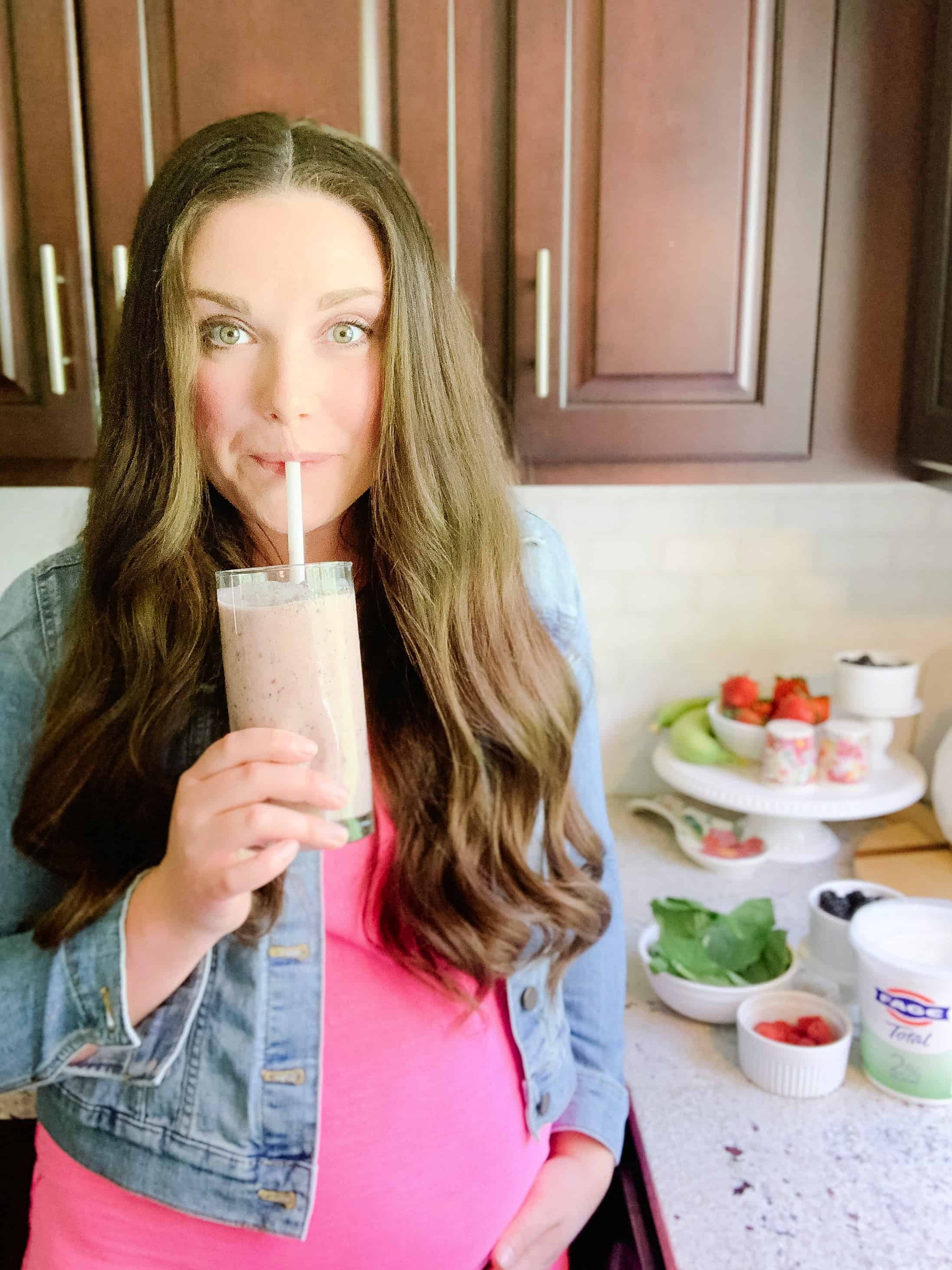 Pregnant woman drinking a smoothie
