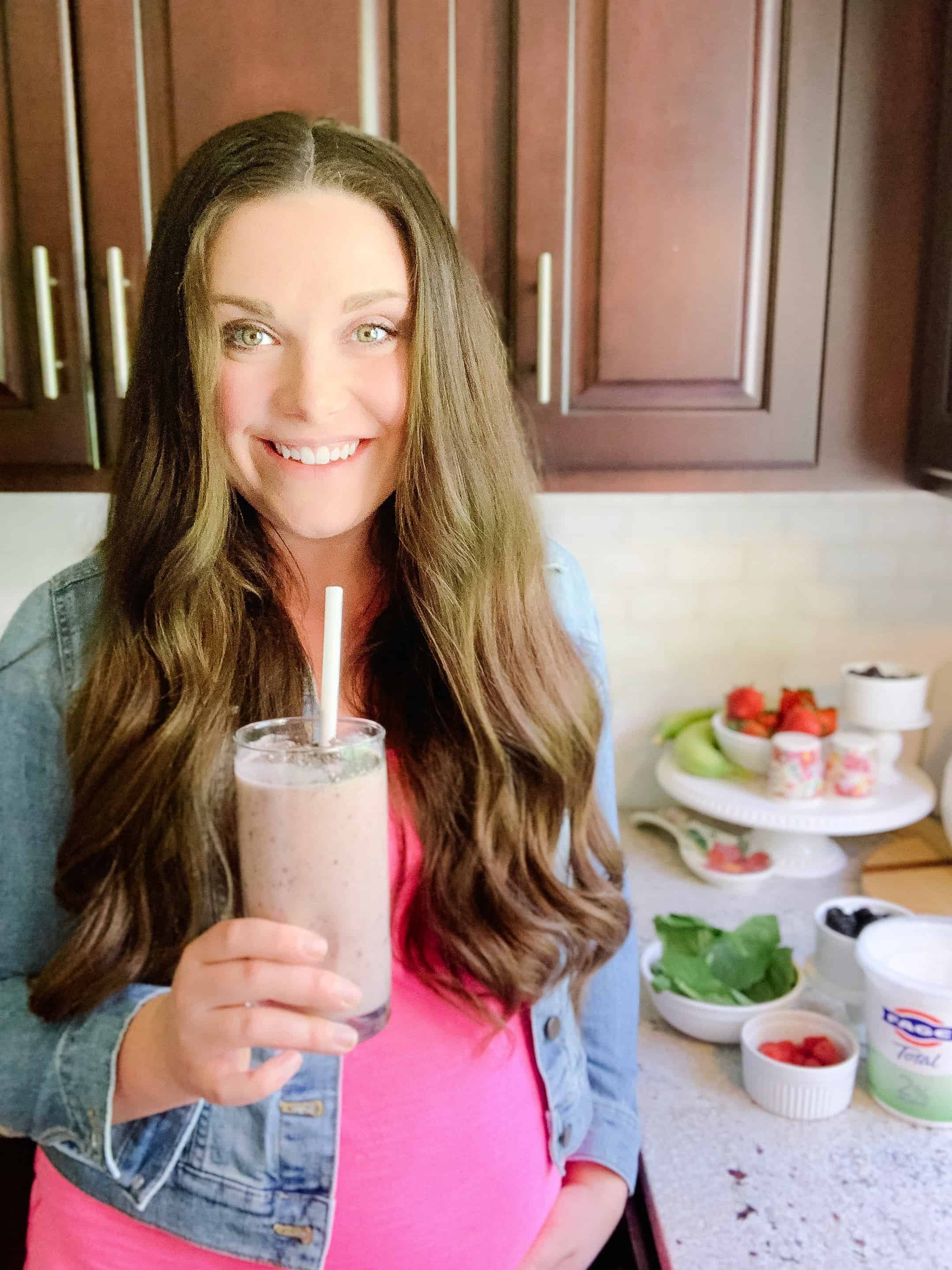 pregnant woman drinking a smoothie