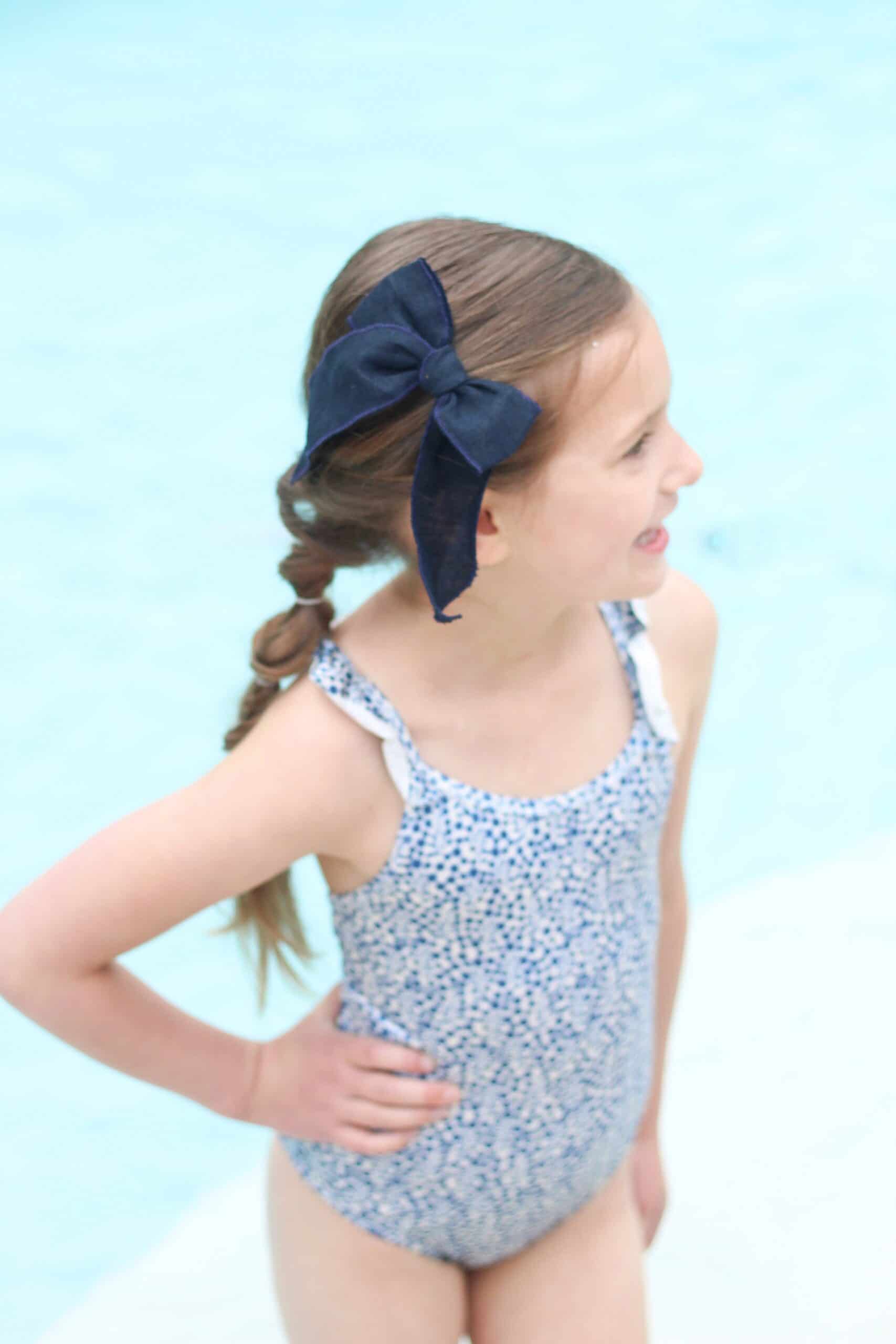 toddler girl in blue swimsuit