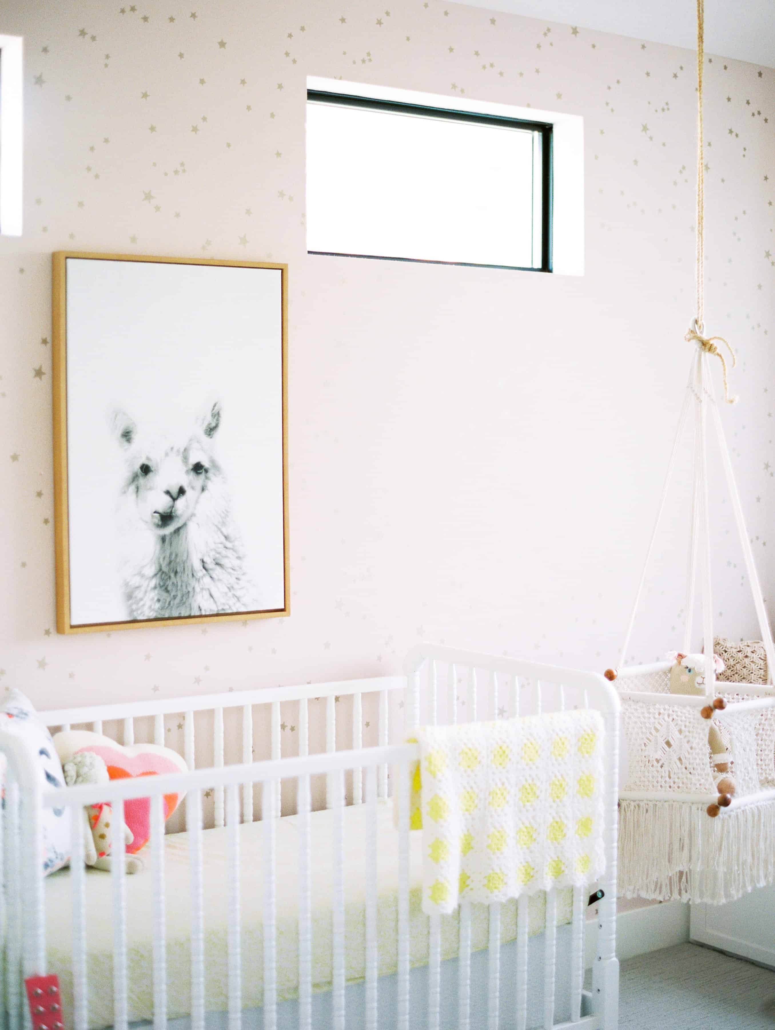 alpaca picture over white crib with pink walls 