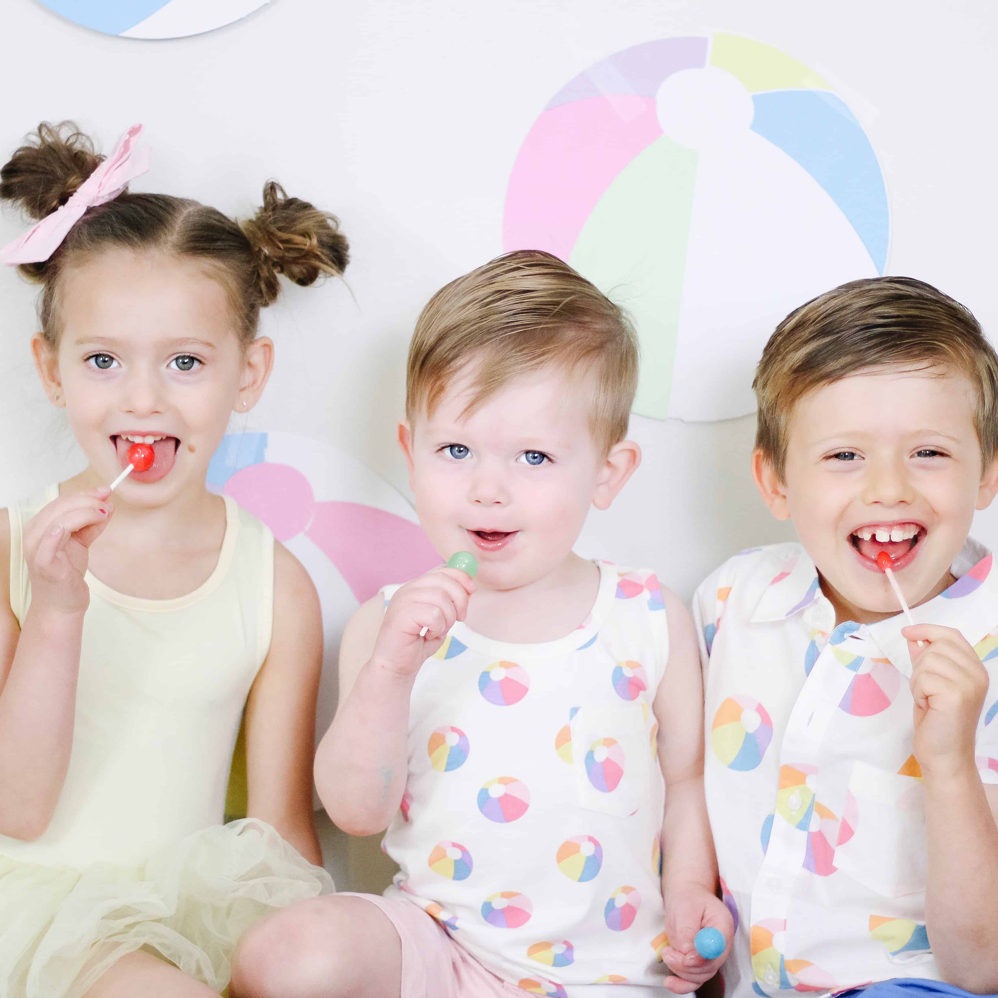 siblings in beach ball outfits