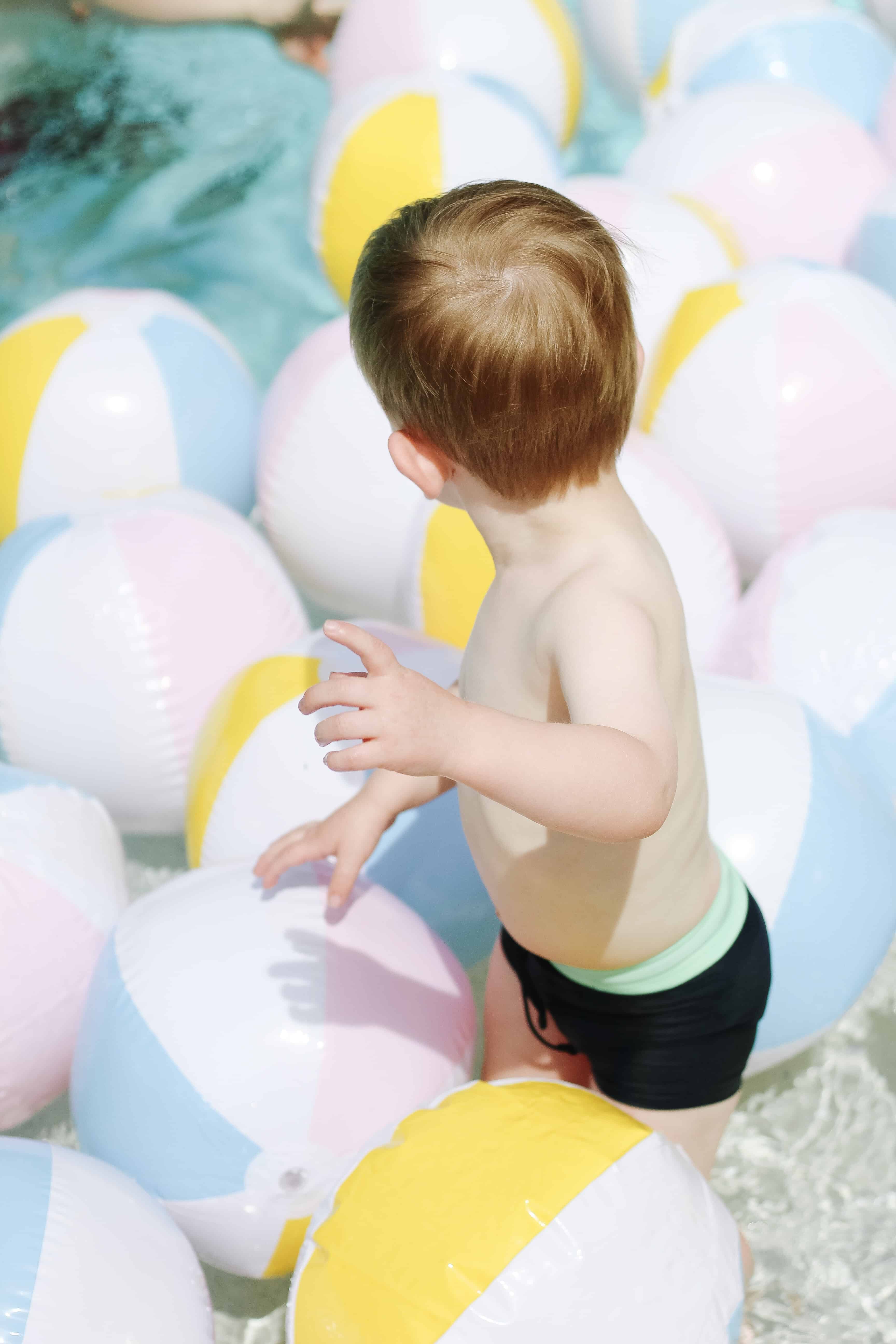 Beach ball filled pool with toddler