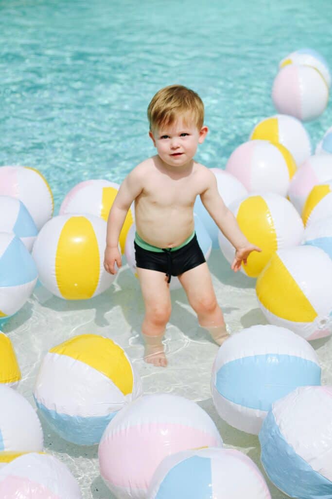 2 year old in pool with beach balls
