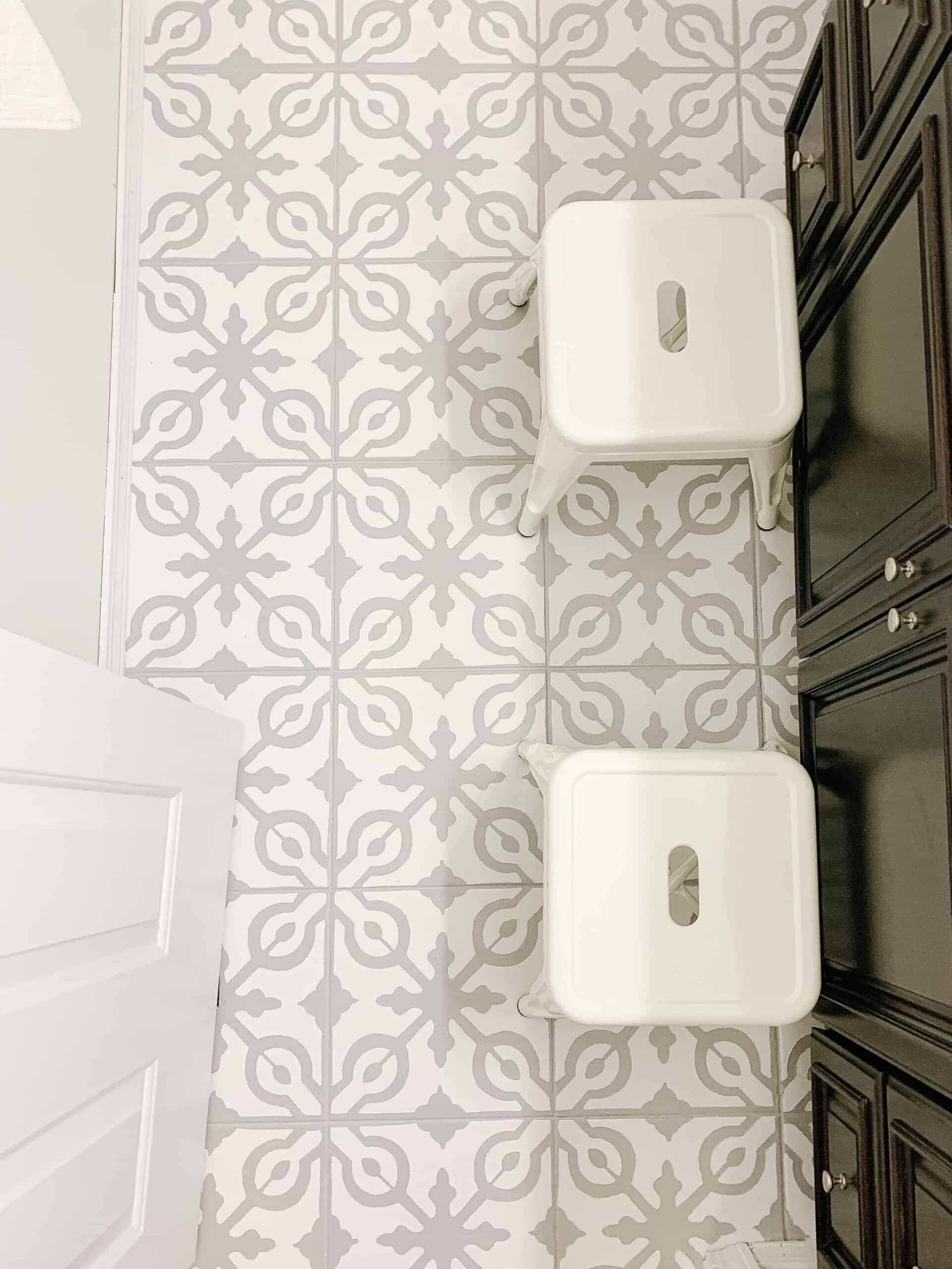 painted tile floors with small white metal stools