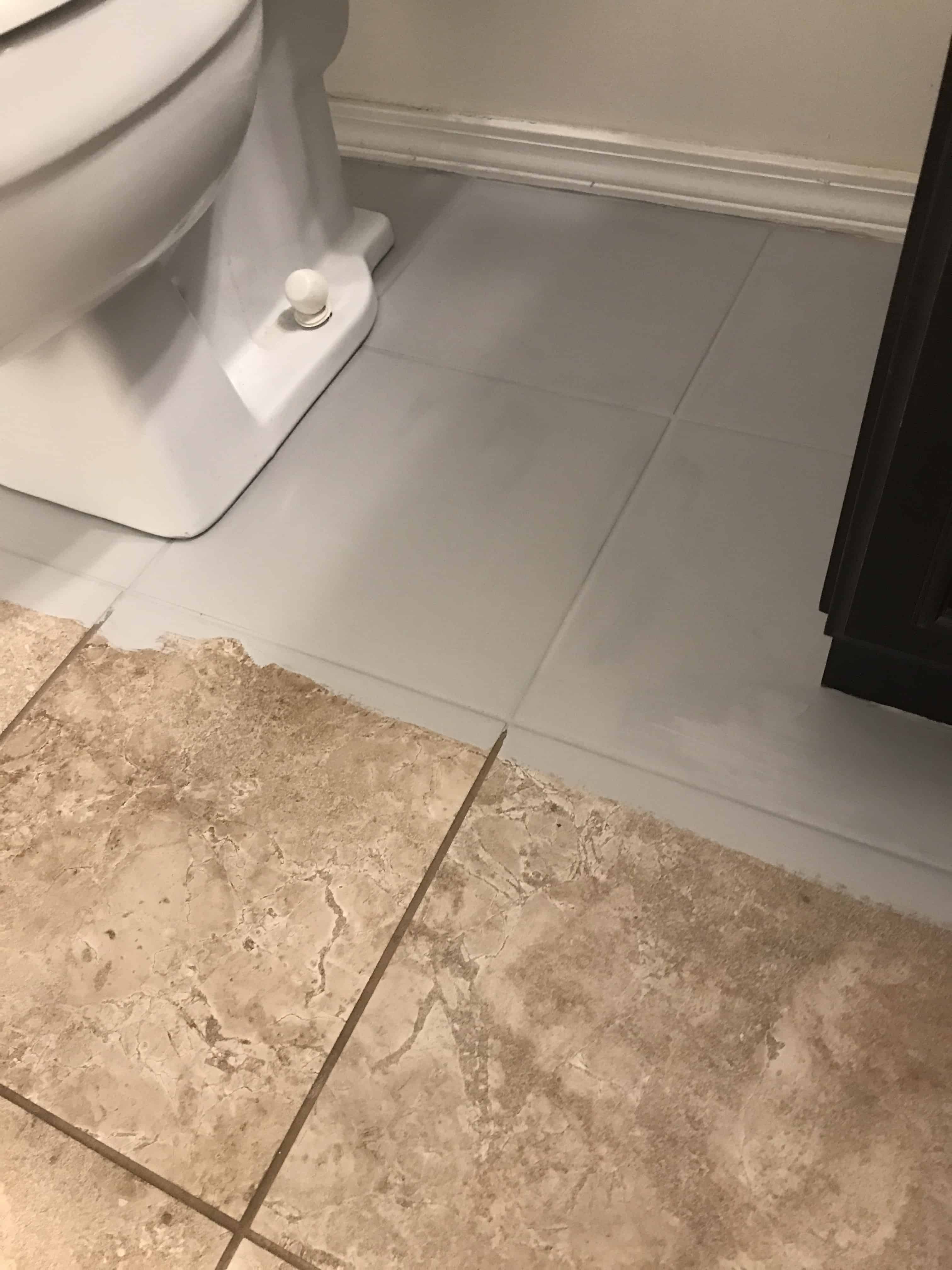 In progress picture of tile floors being painted grey
