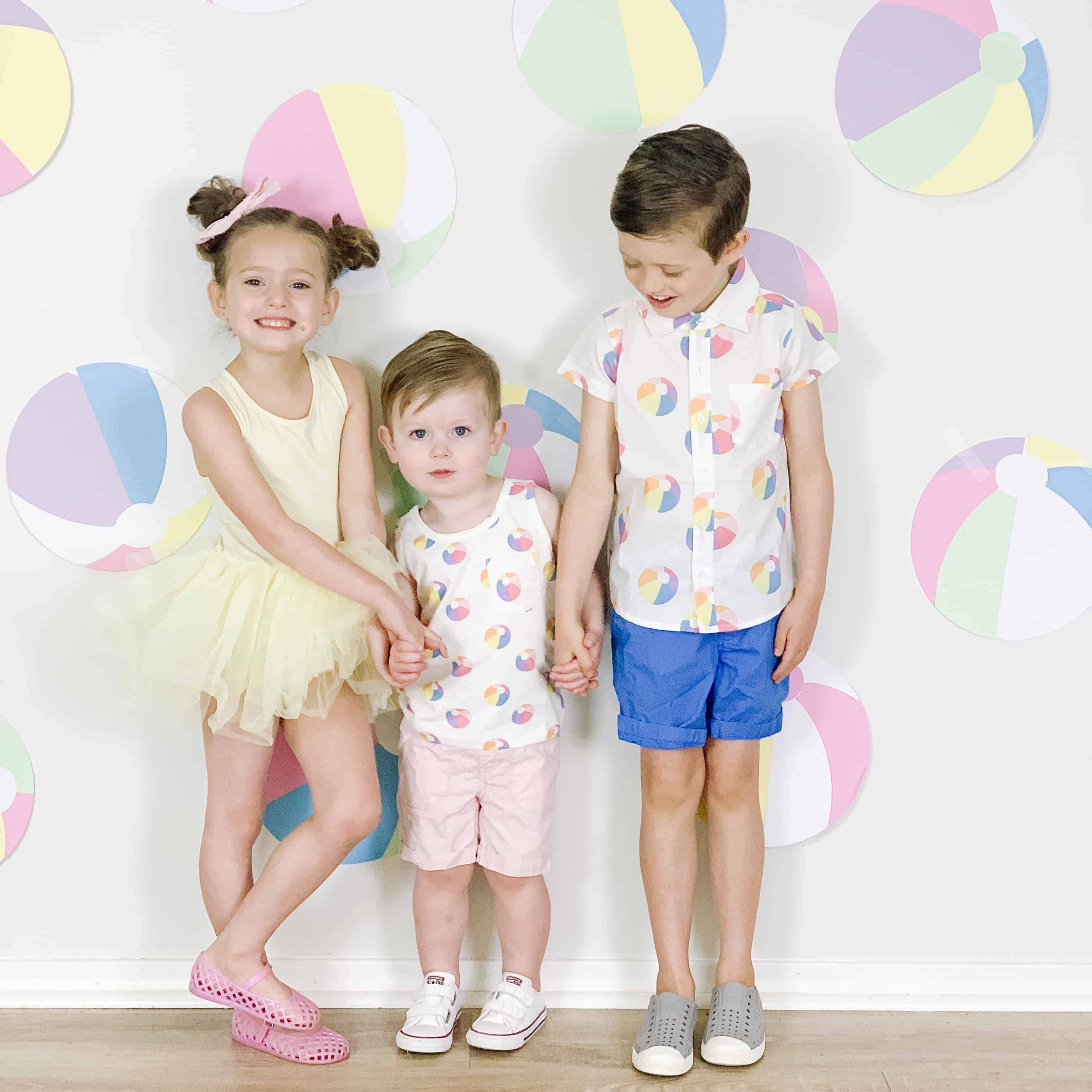 Siblings in yellow tutu and beach ball outfits