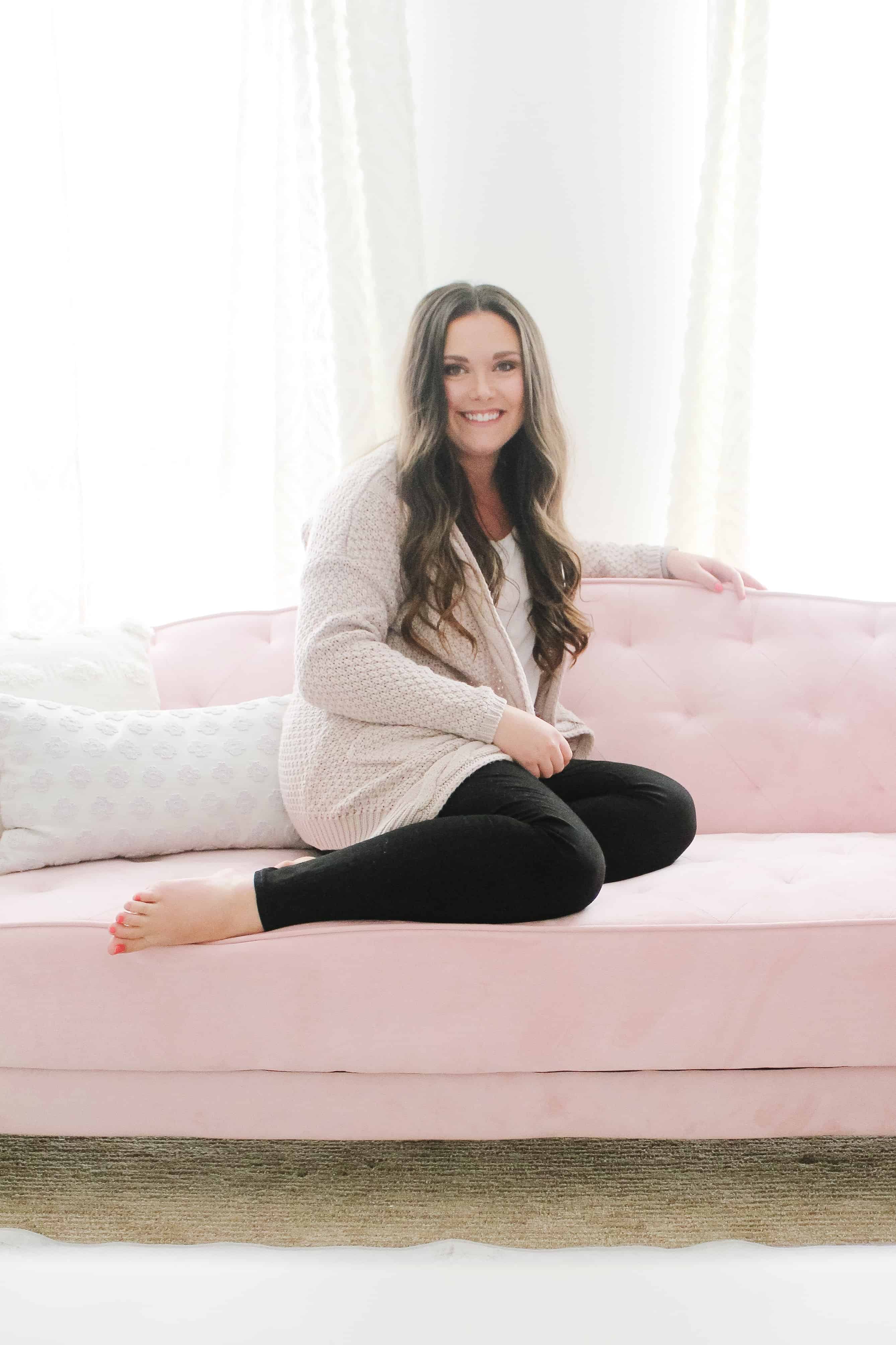 mom sitting on pink couch