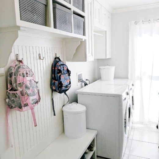 Laundry room with pottery barn kids backpacks hanging