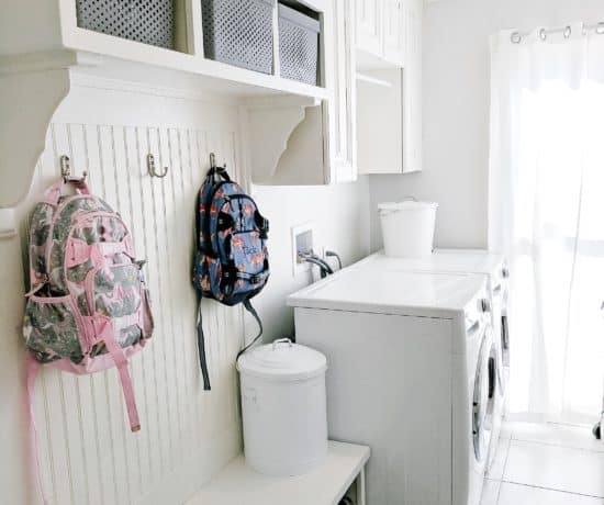 Laundry room with pottery barn kids backpacks hanging