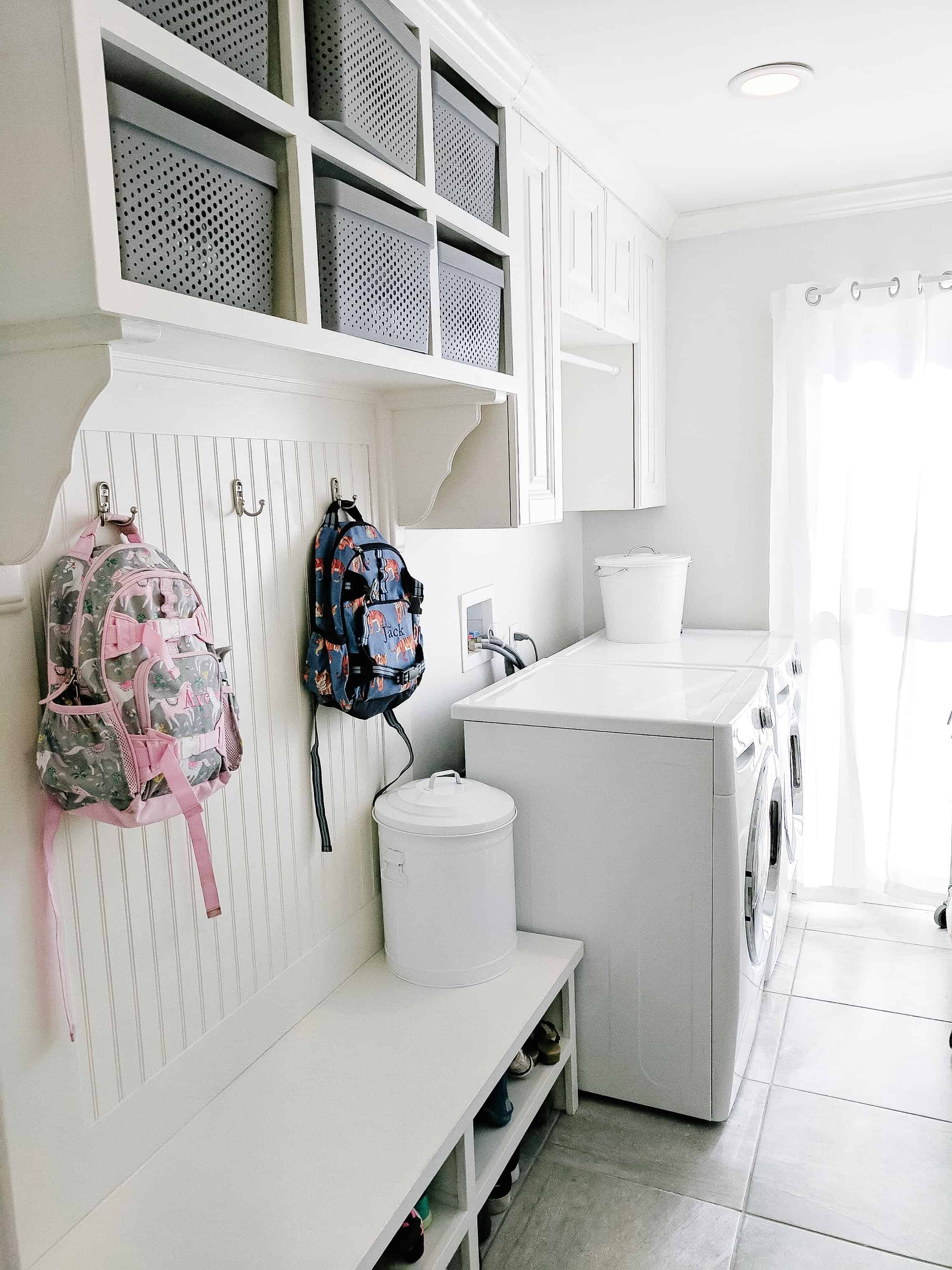 Laundry room with pottery barn kids backpacks hanging