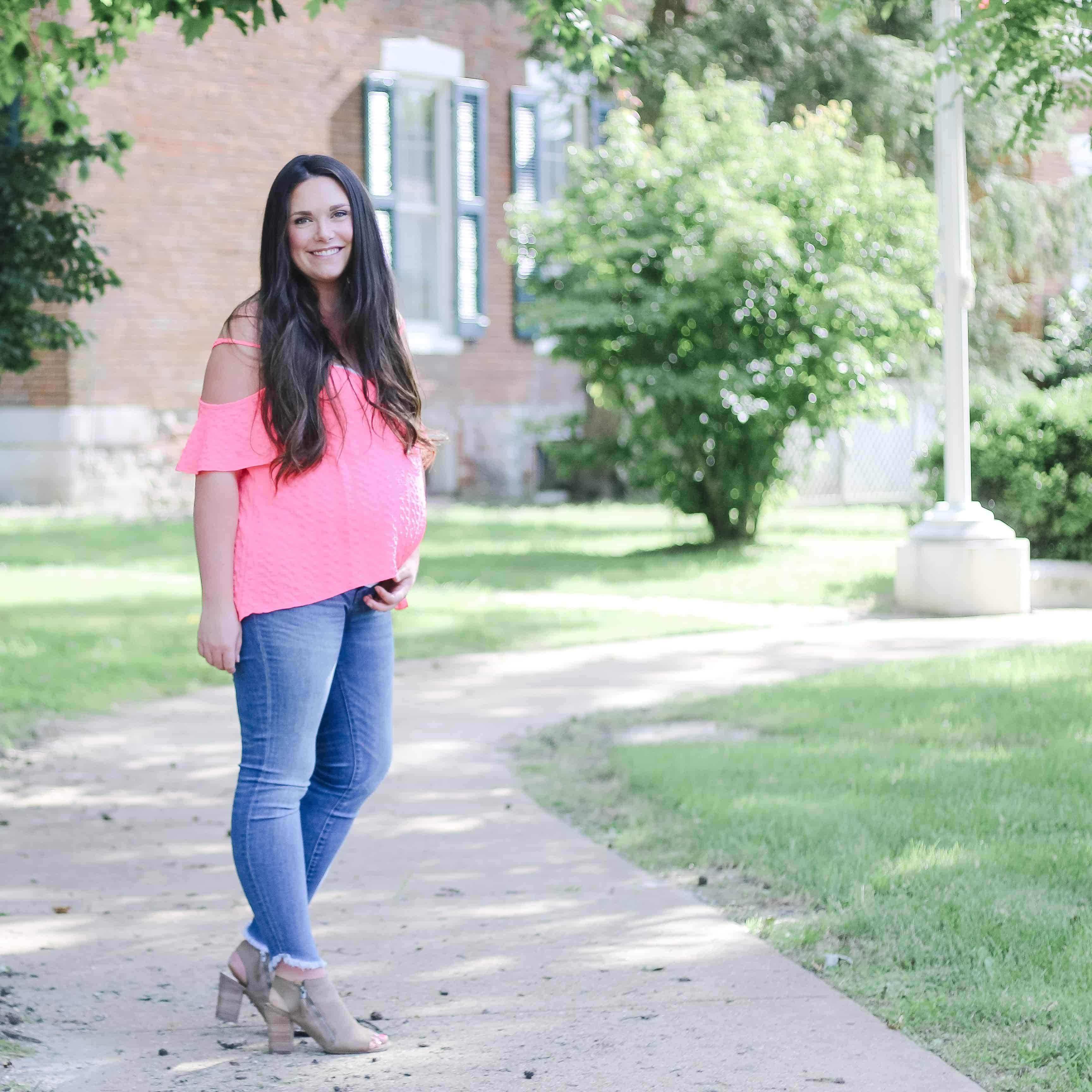 Pregnant woman in madewell jeans and a pink top