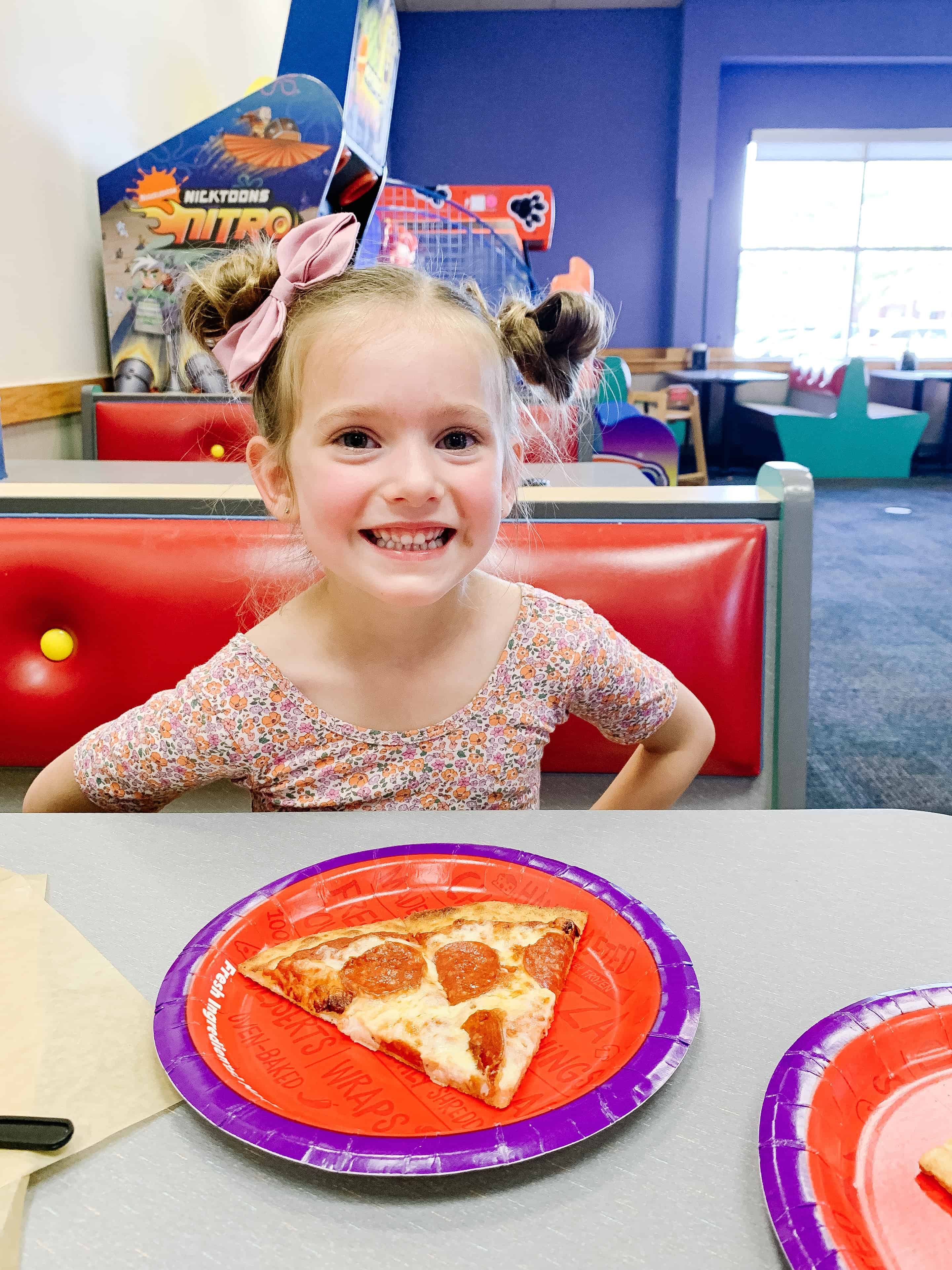 Chuck E. Cheese pizza and toddler girl