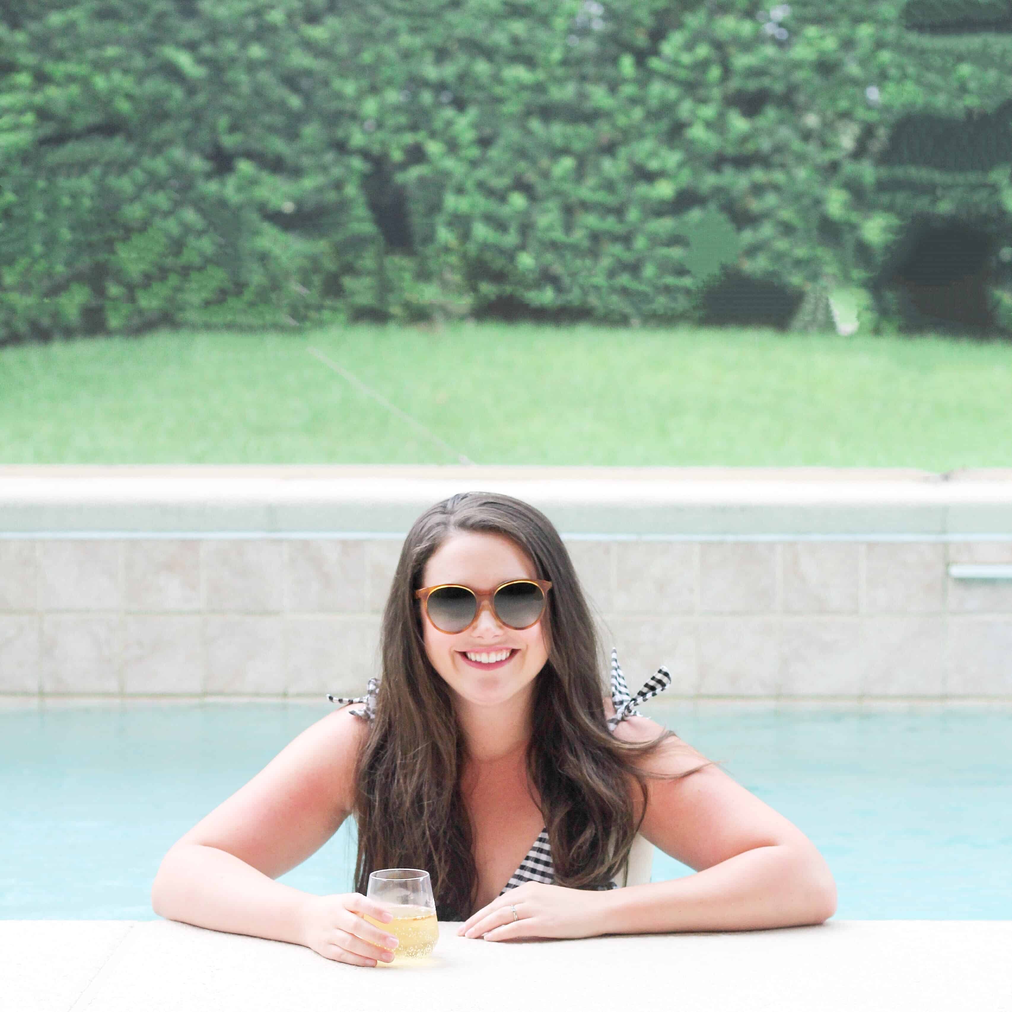 mom drinking wine in a pool