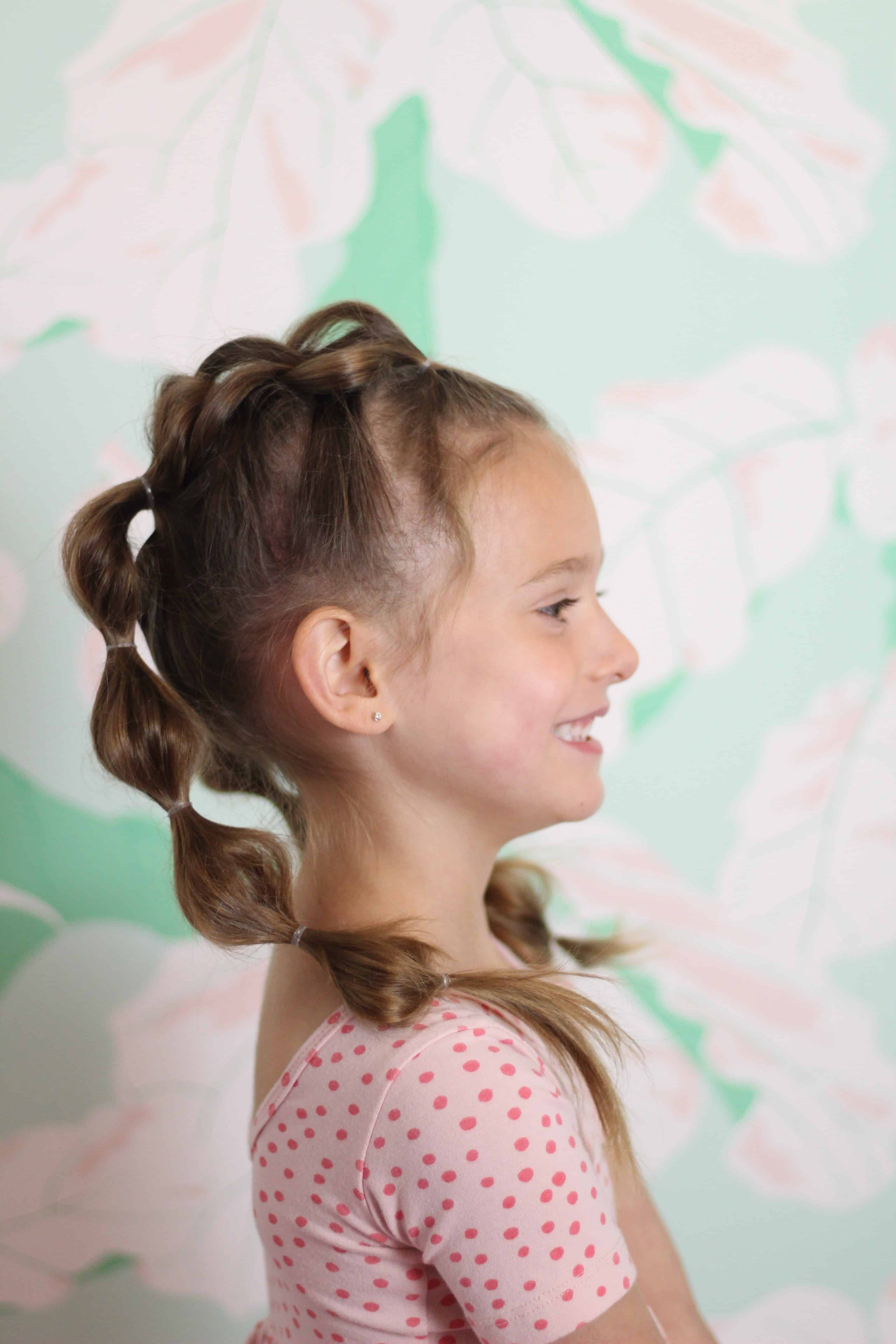 Toddler Girl with Bubble Braids in front of floral wall