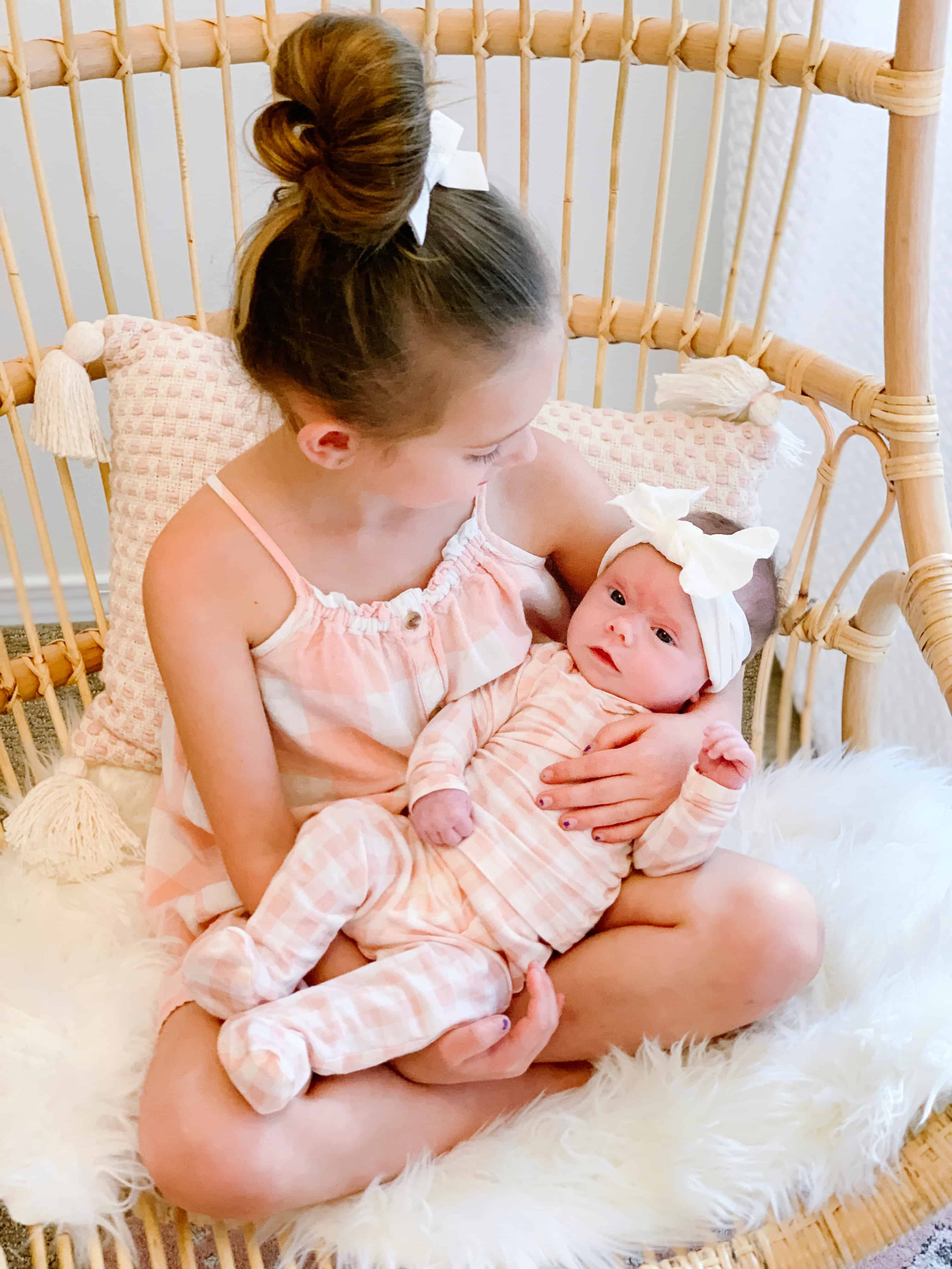 Sisters in matching pink gingham in Serena and Lily Chair