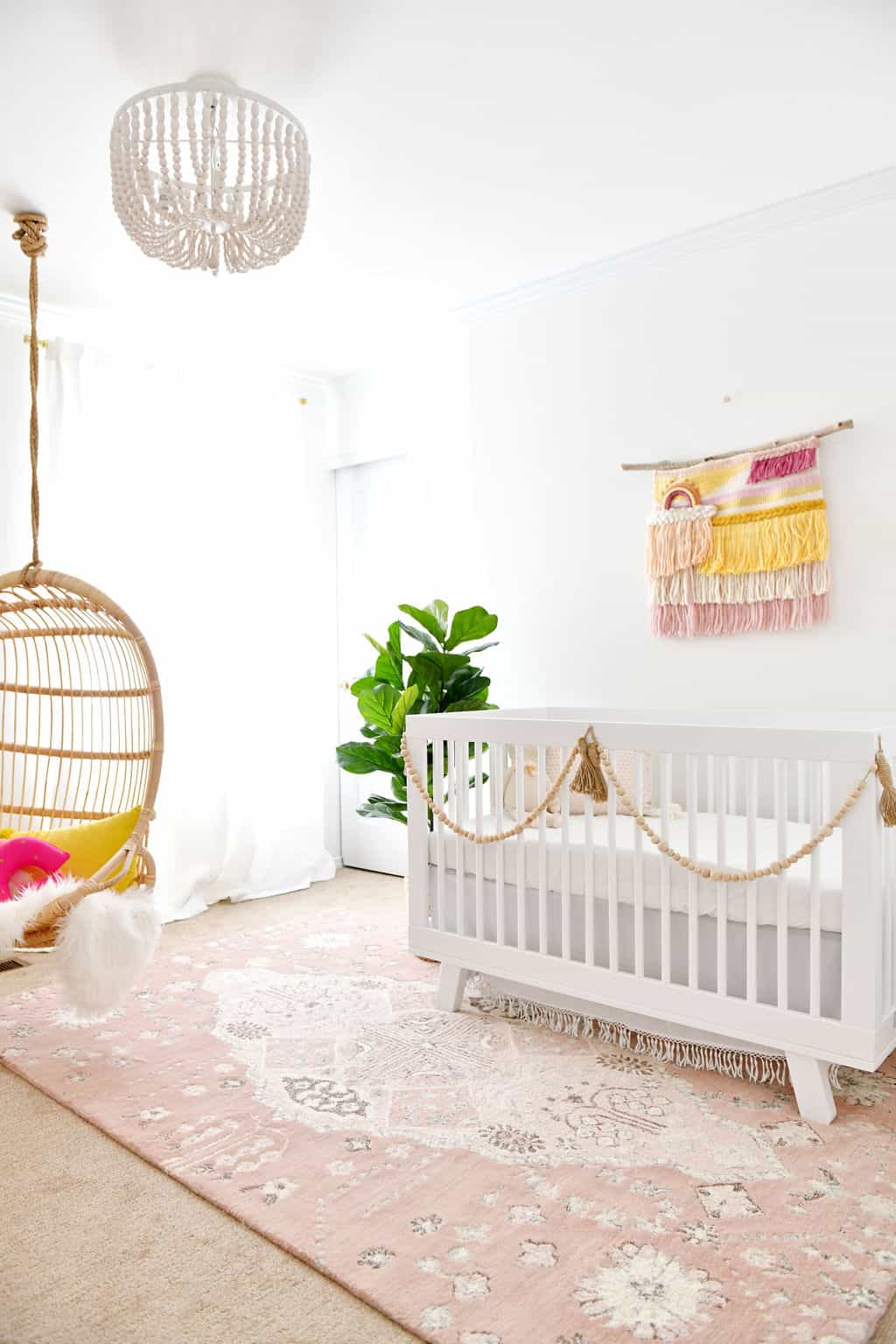 Baby nursery with rainbow and pink accents