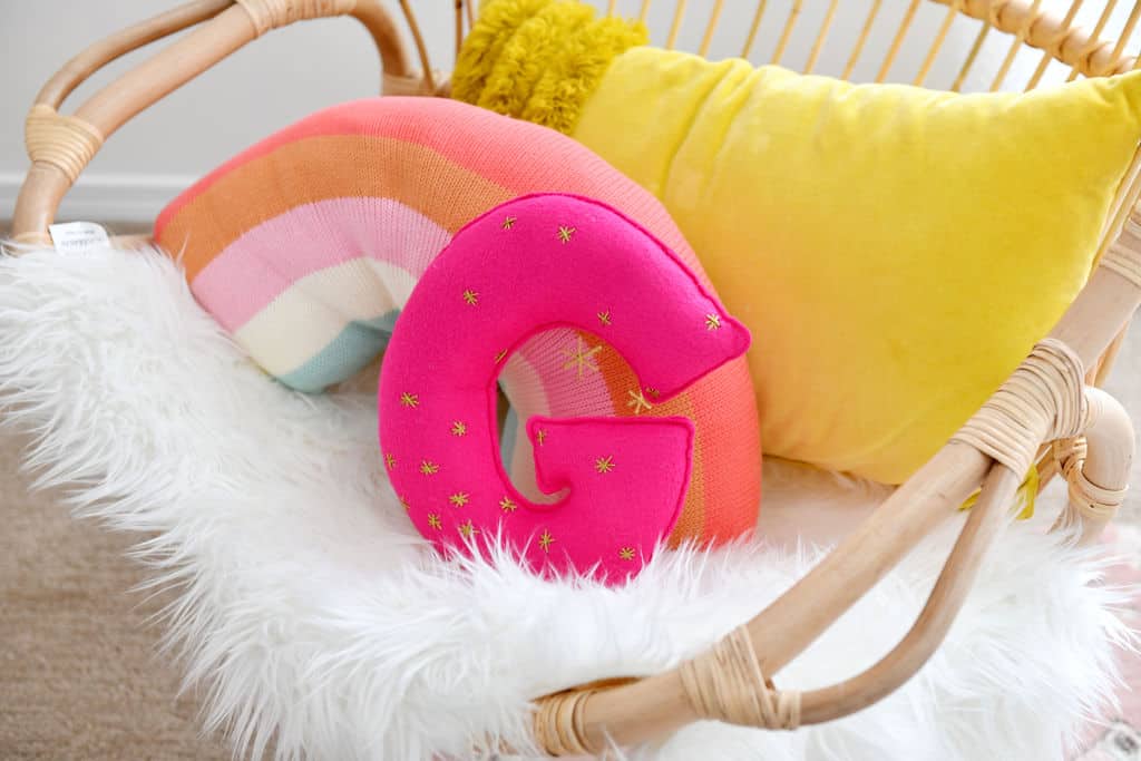 Rattan Chair with rainbow and G pillows