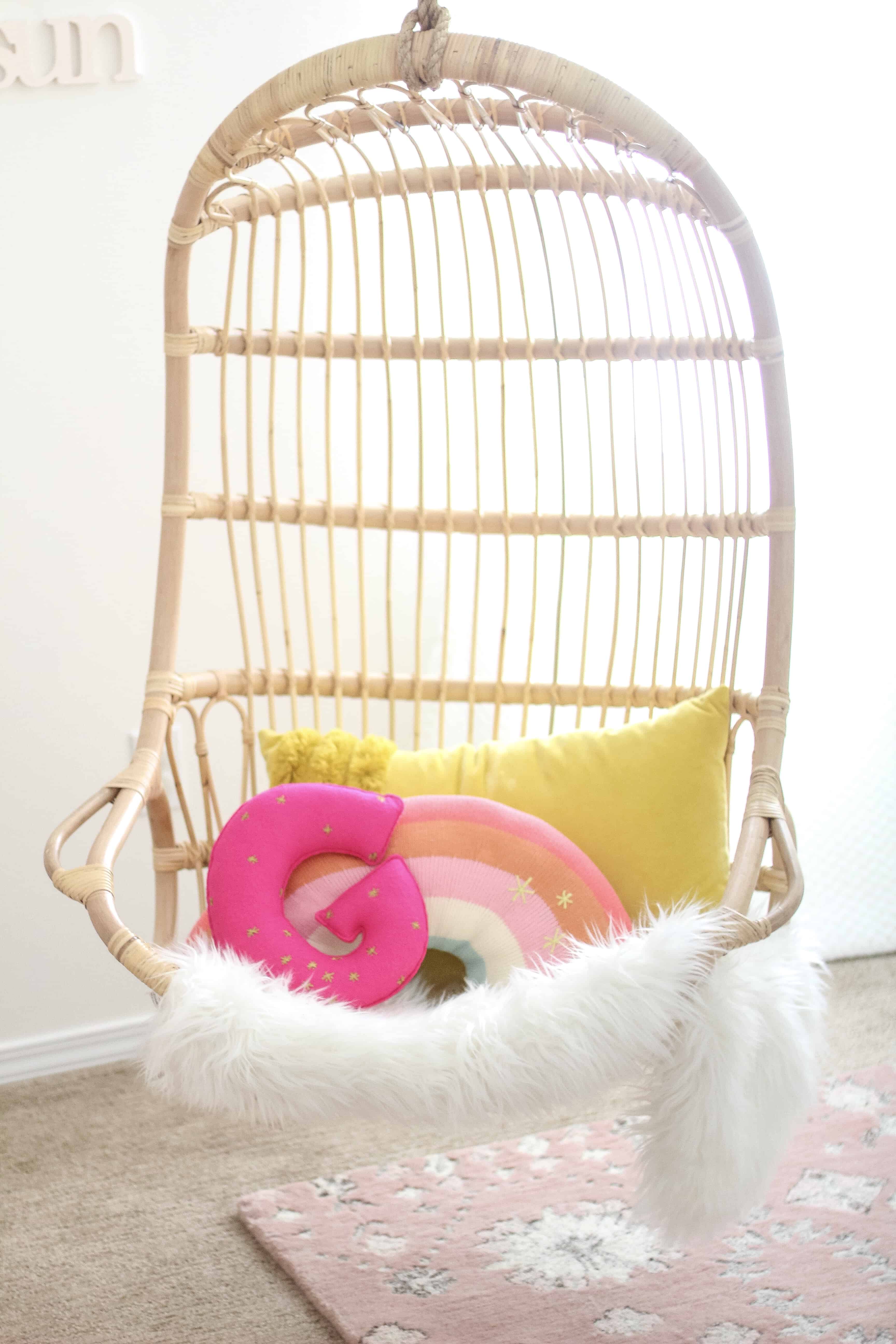 Hanging Serena and lily chair with rainbow and G pillow