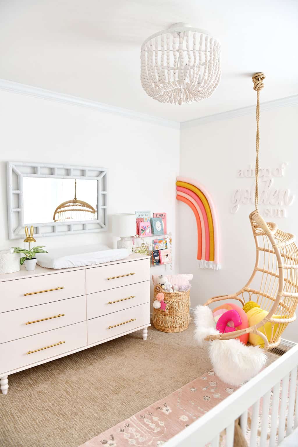 Pink Ikea dresser in room with rainbow