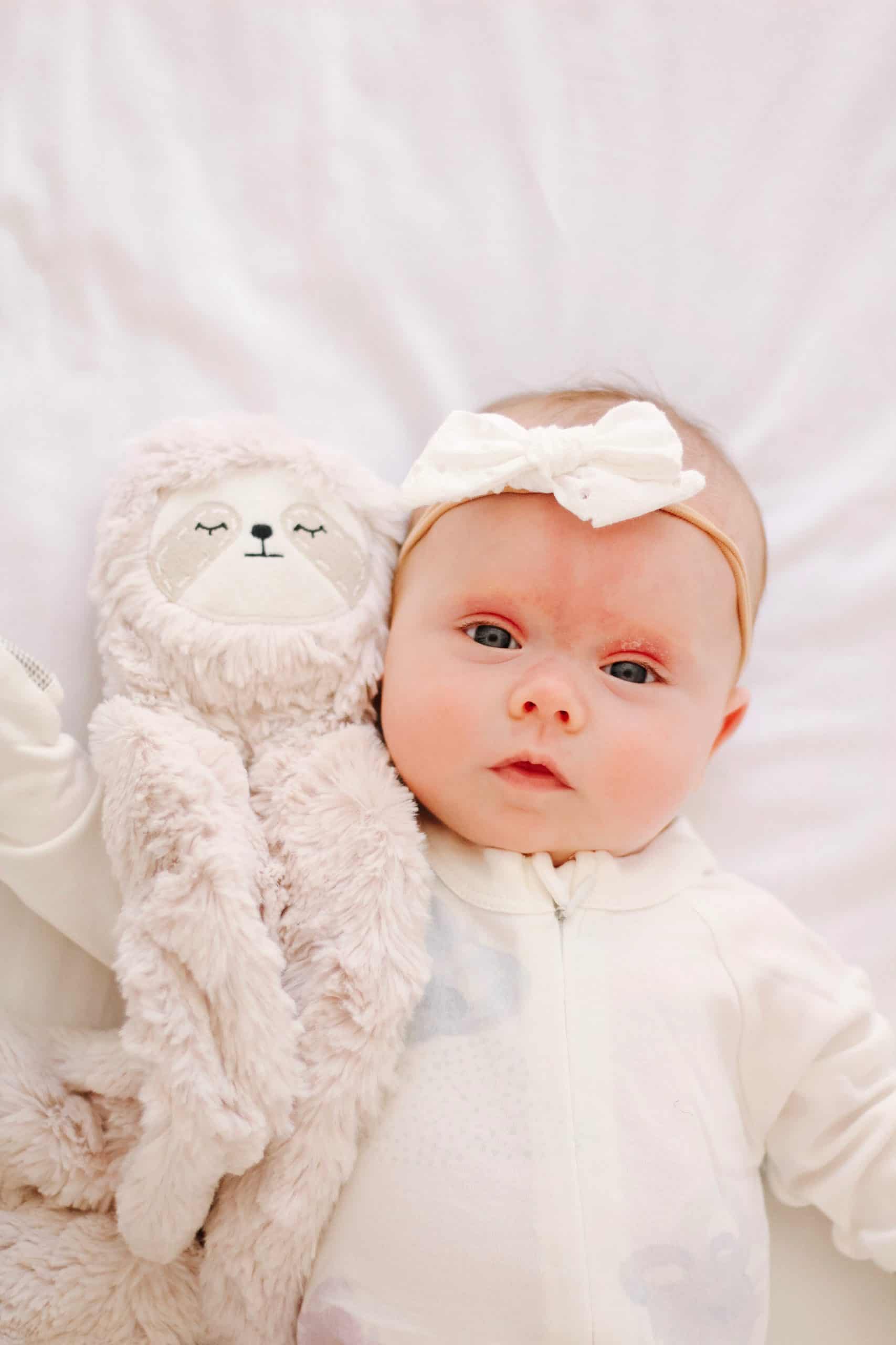 baby girl with slumberkins sloth