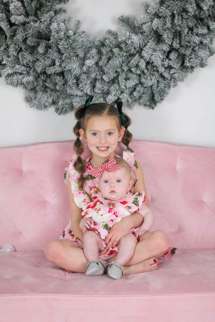 sisters in pink Santa outfit 