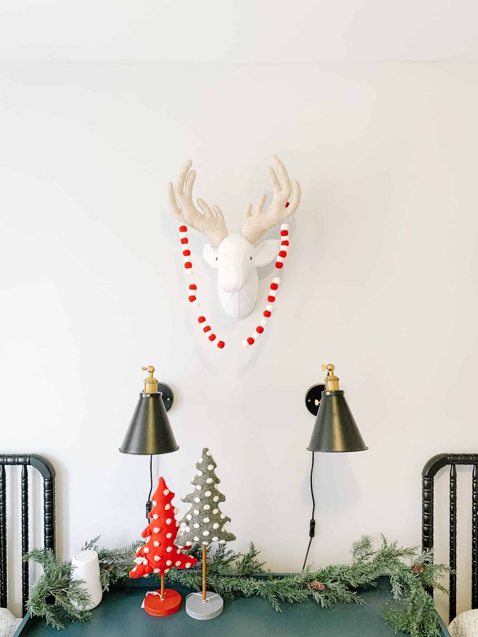 Wall in Boys room decorated with felt deer head and Christmas Garland