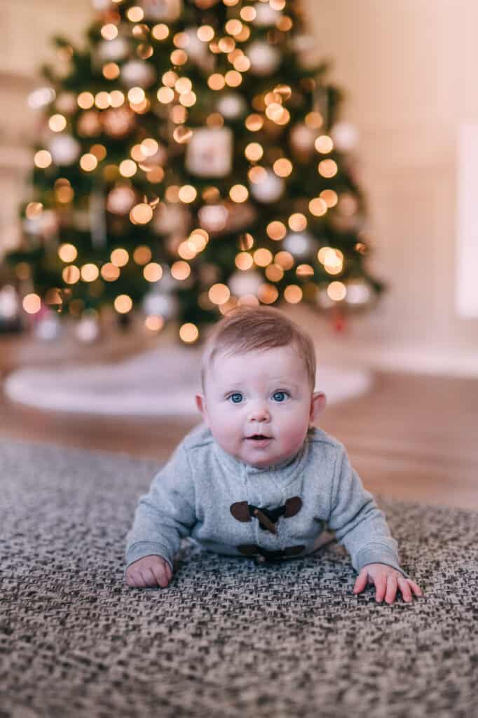 baby boy in front of Christmas tree
