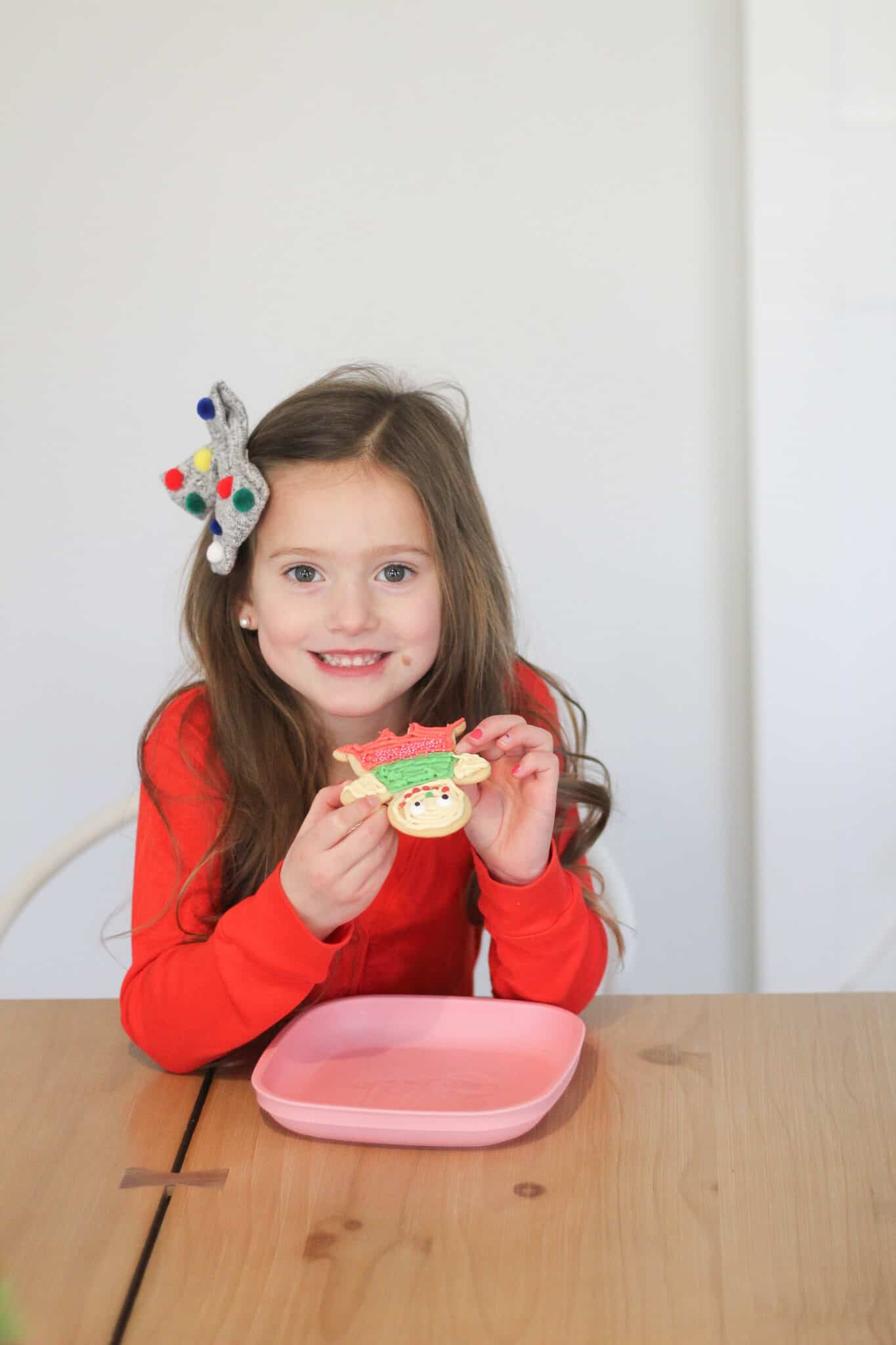 little girl eating a Christmas cookie