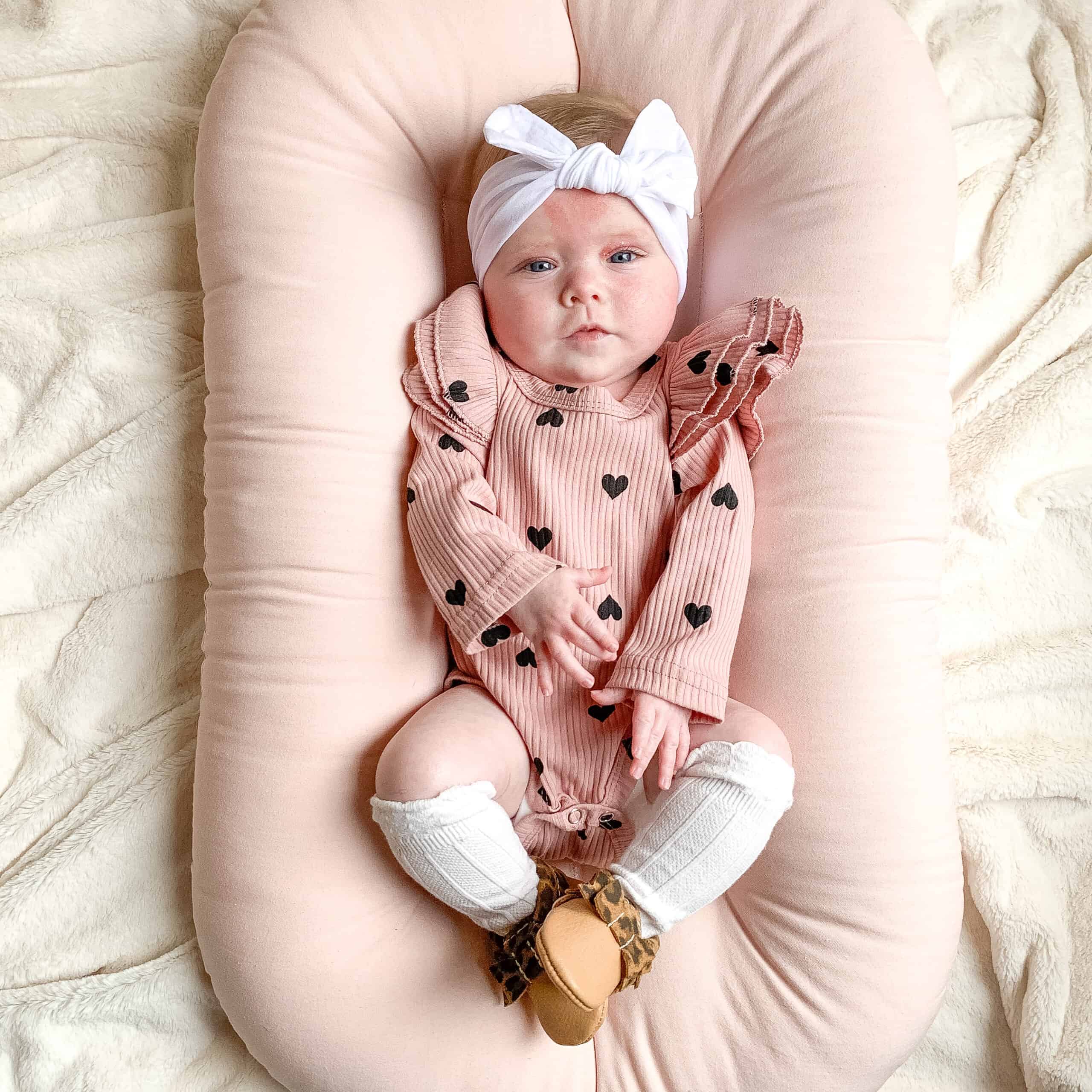 Baby girl on pink snuggle me organic