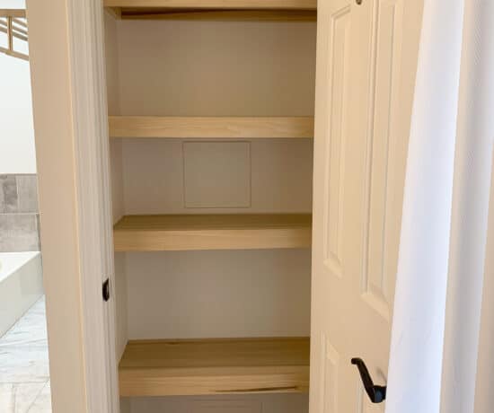 Linen closet with wood shelves