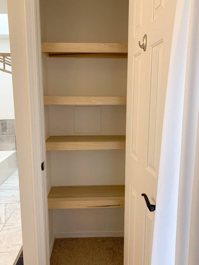 Linen closet with wood shelves