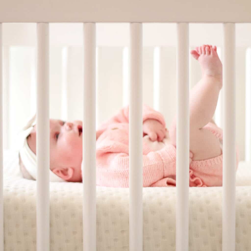 5 month old baby in her crib