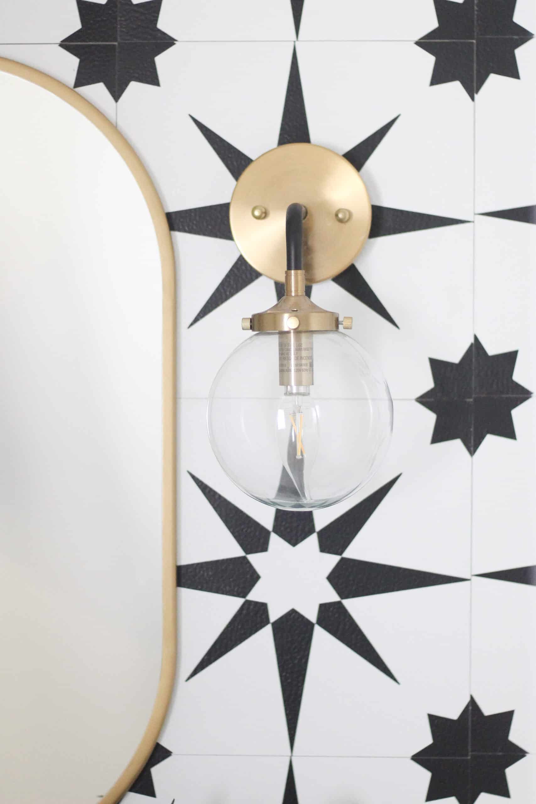 Gold and black wall sconce with gold mirror