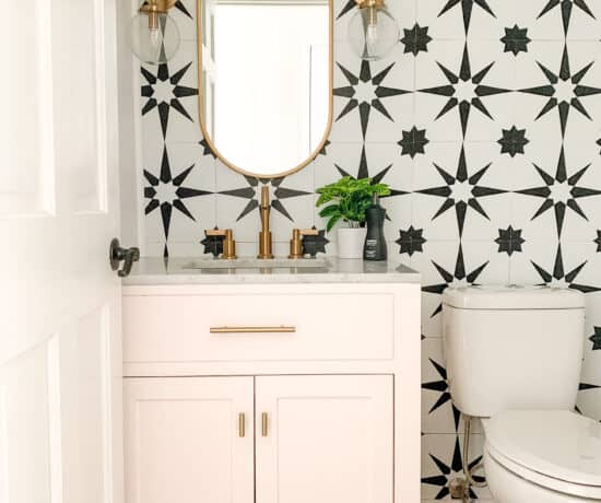 Bold pink powder room with black and white tile wall