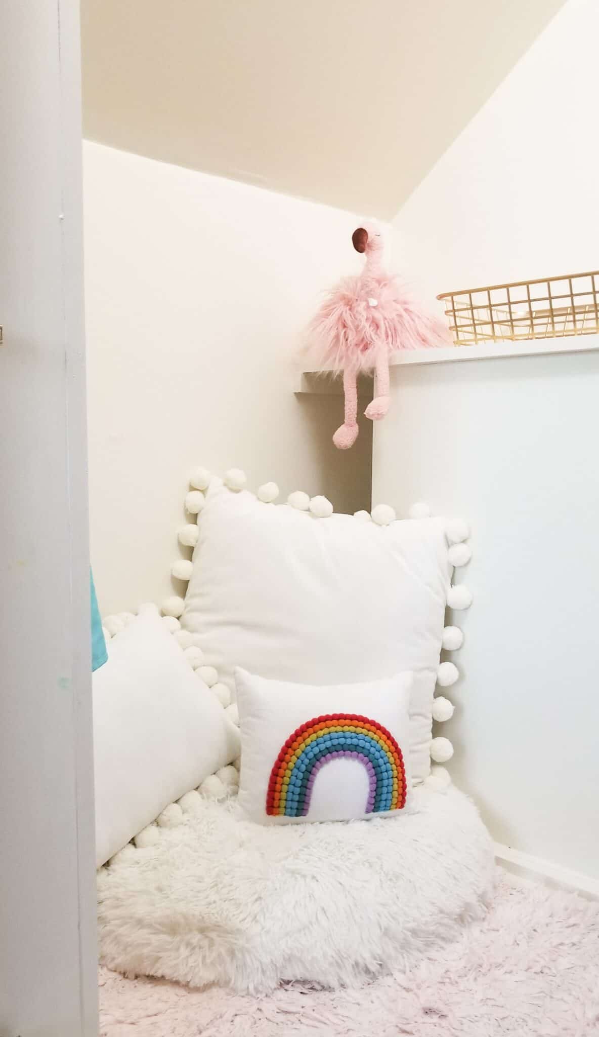 rainbow pillow in under stairs nook