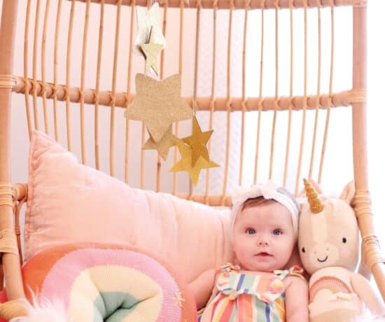 baby girl in hanging Serena and lily chair