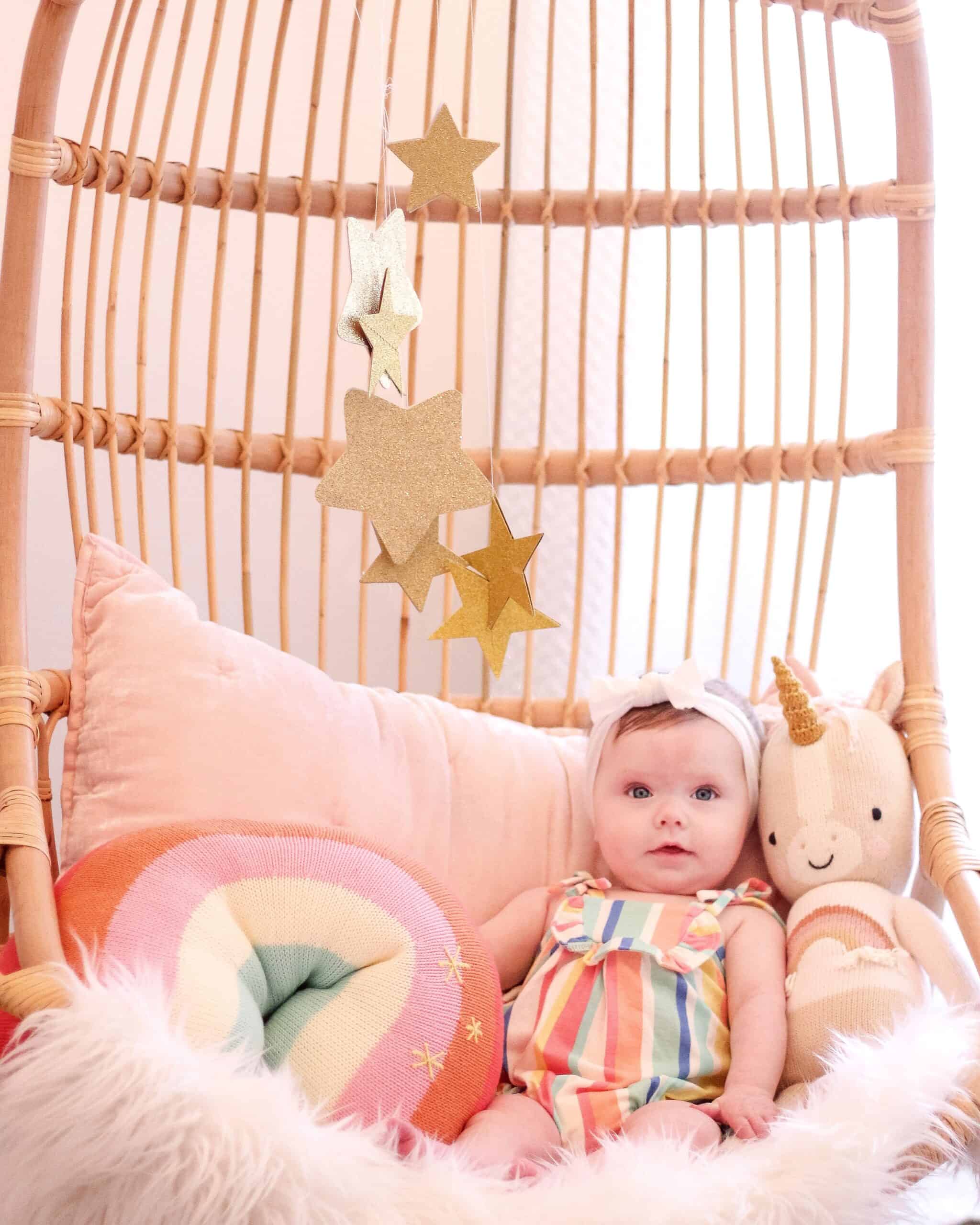 baby girl in hanging Serena and lily chair