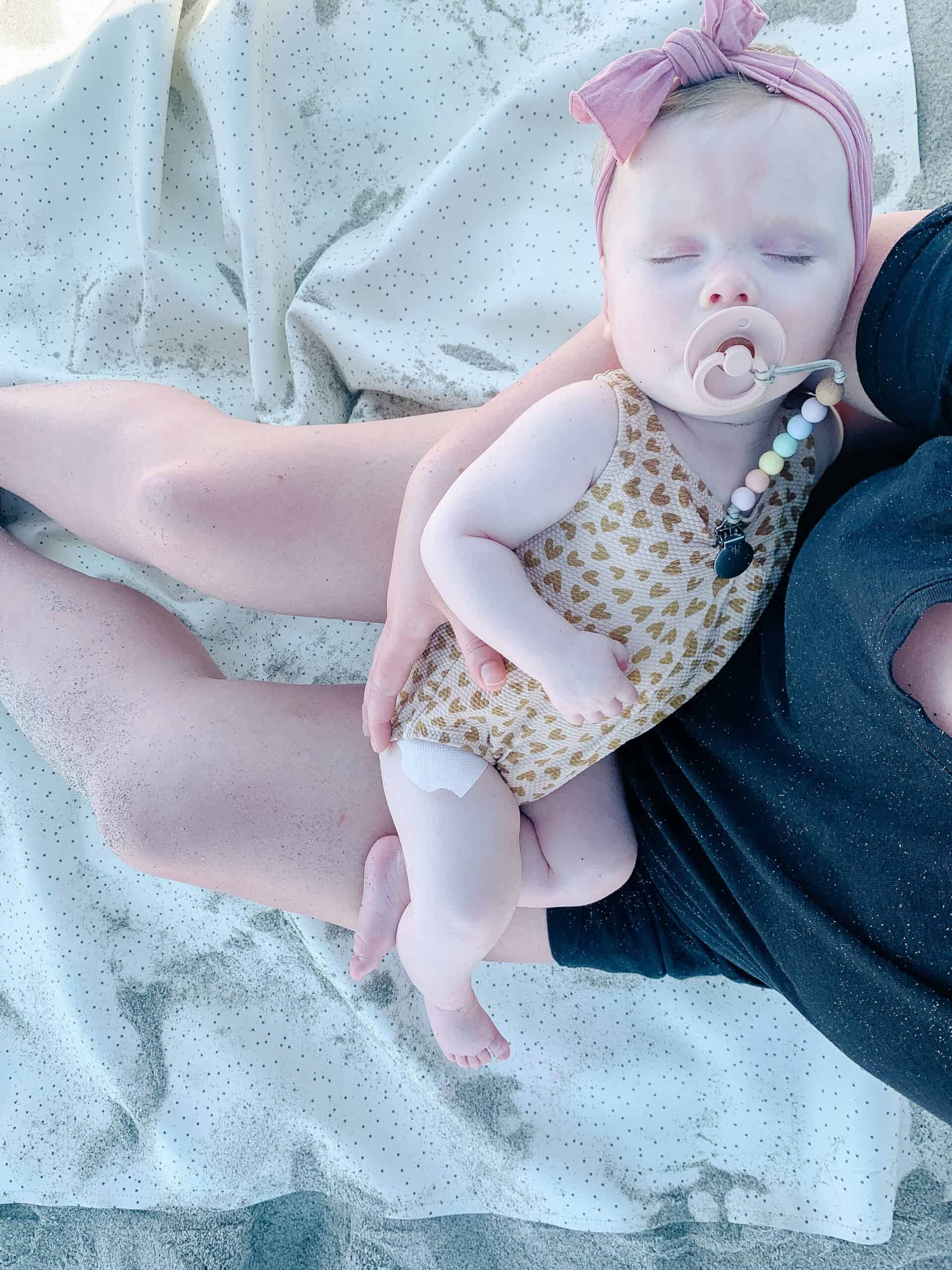 baby girl sleeping on the beach