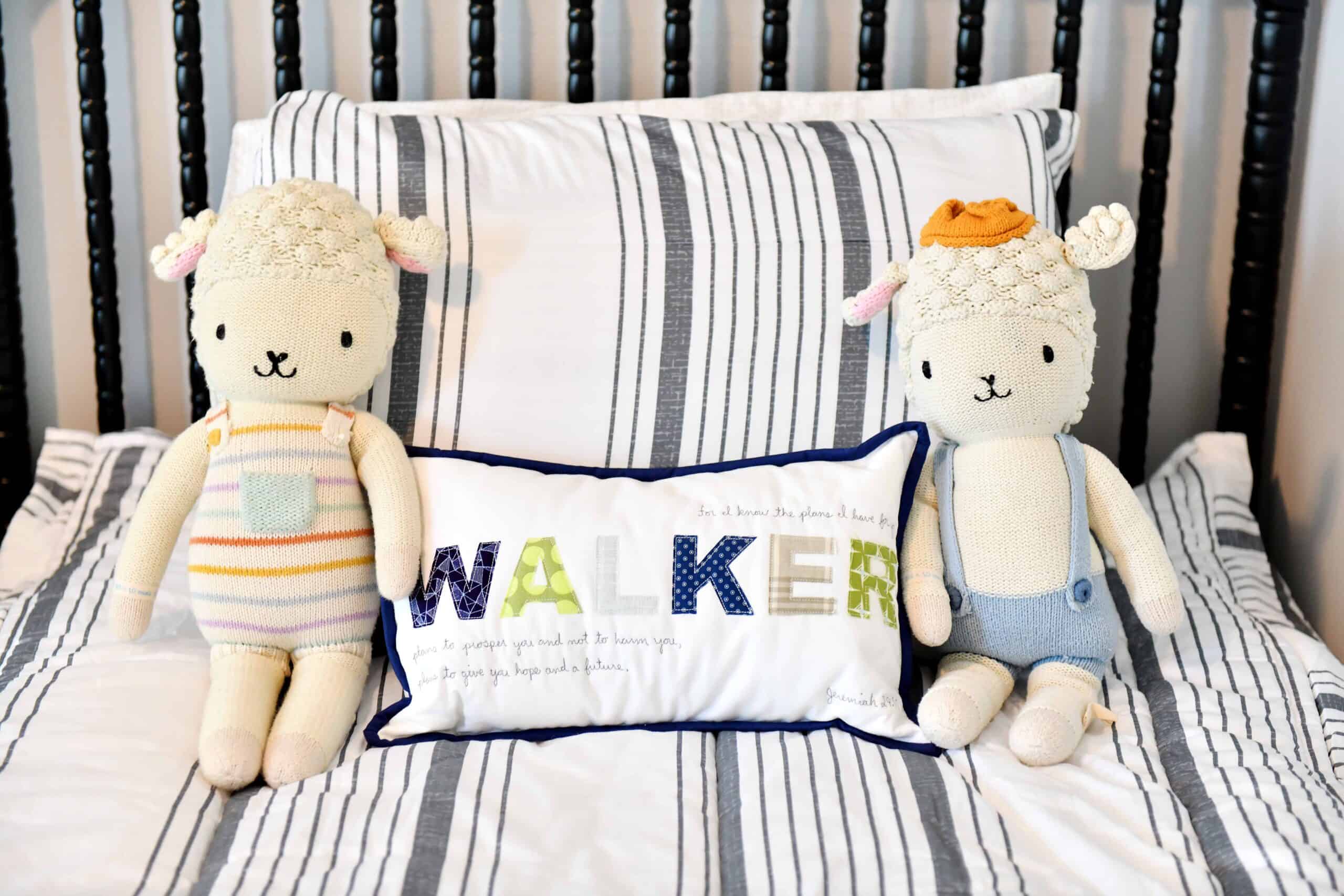 Boys bed with name pillow and cuddle and kind dolls