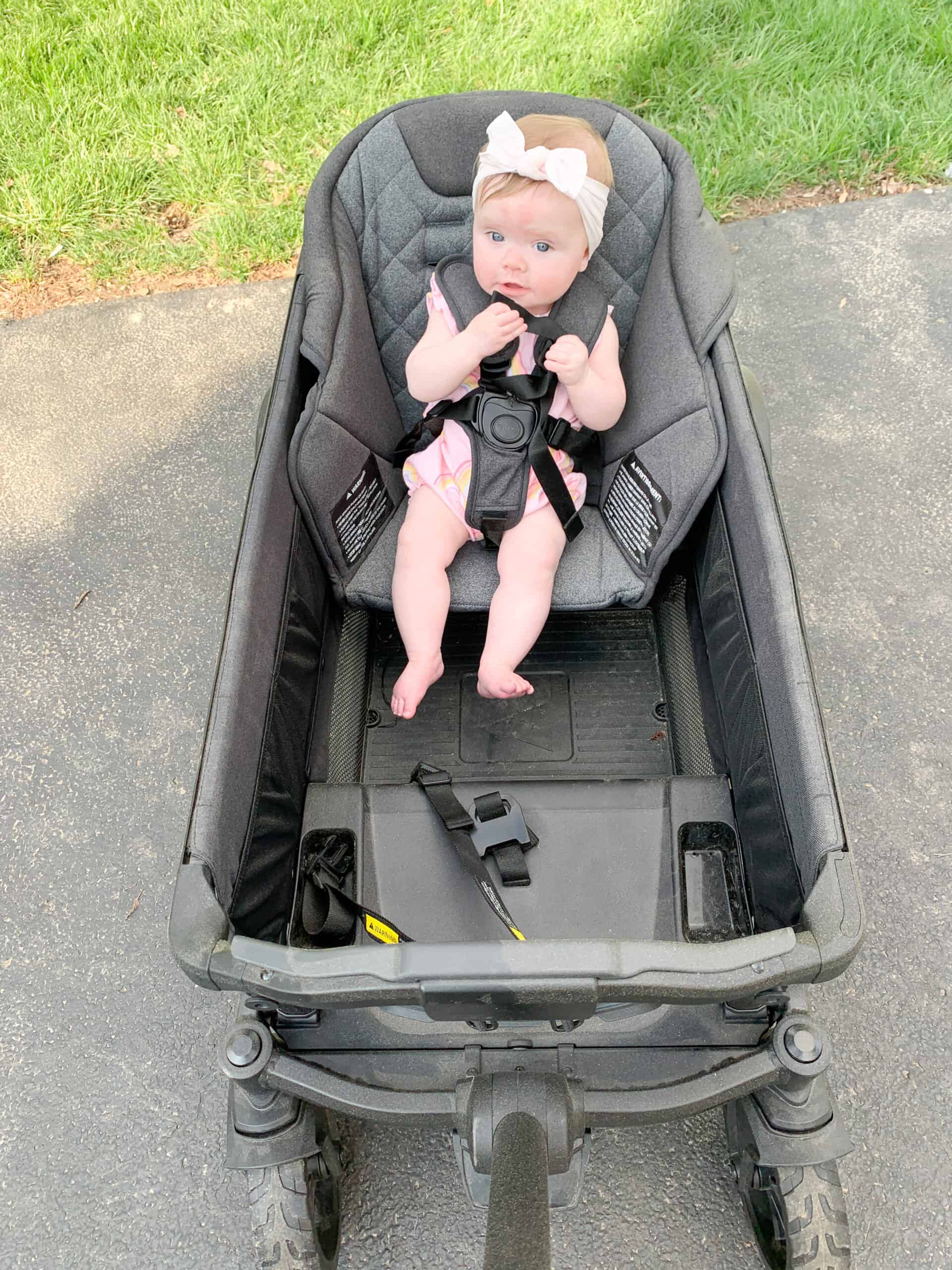 Baby girl in Veer wagon toddler seat