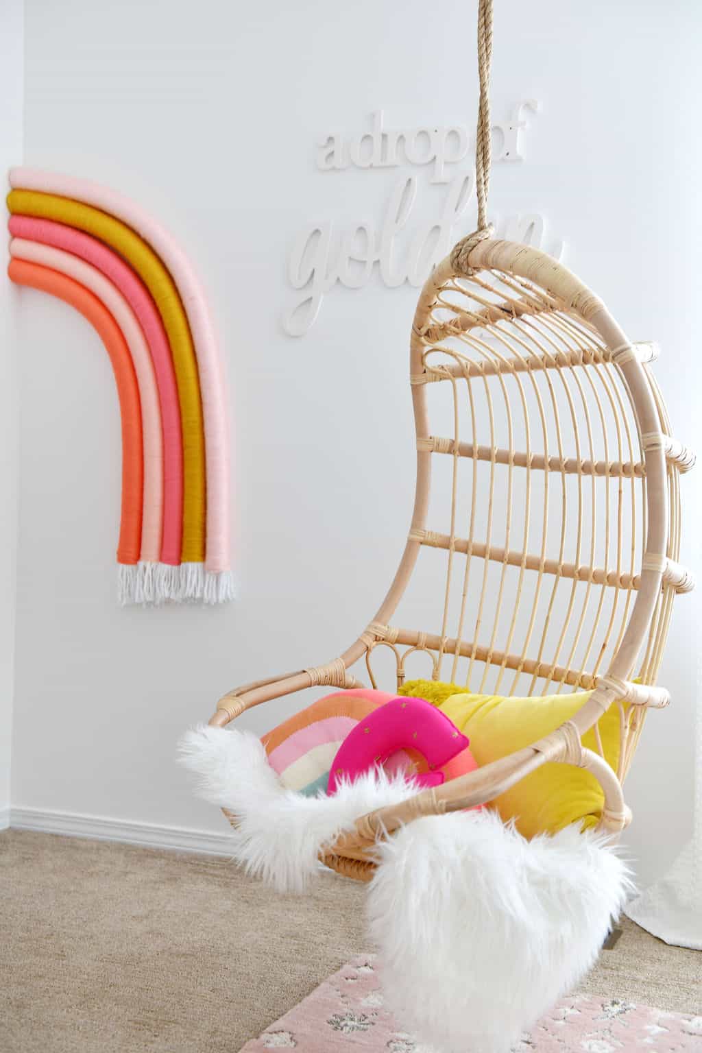 Hanging swing chair from Serena and Lily with wall rainbow