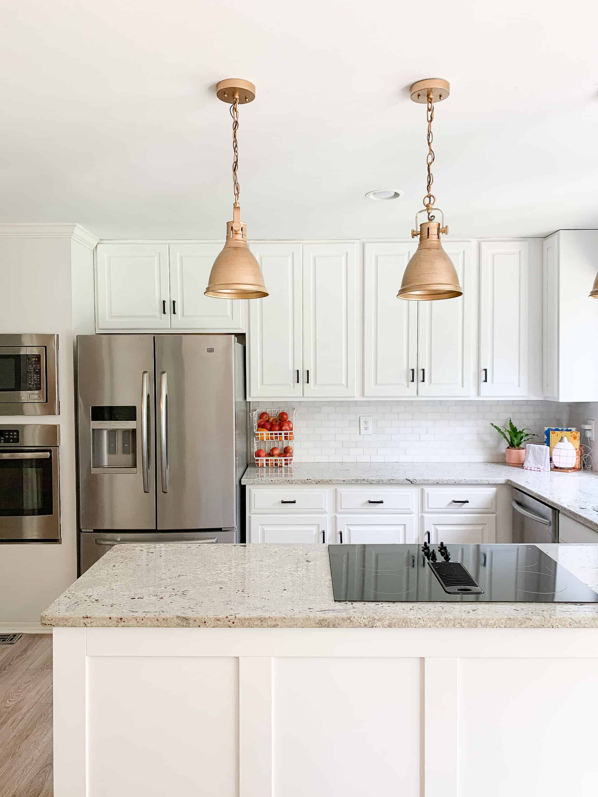 white kitchen cabinets with gold lights