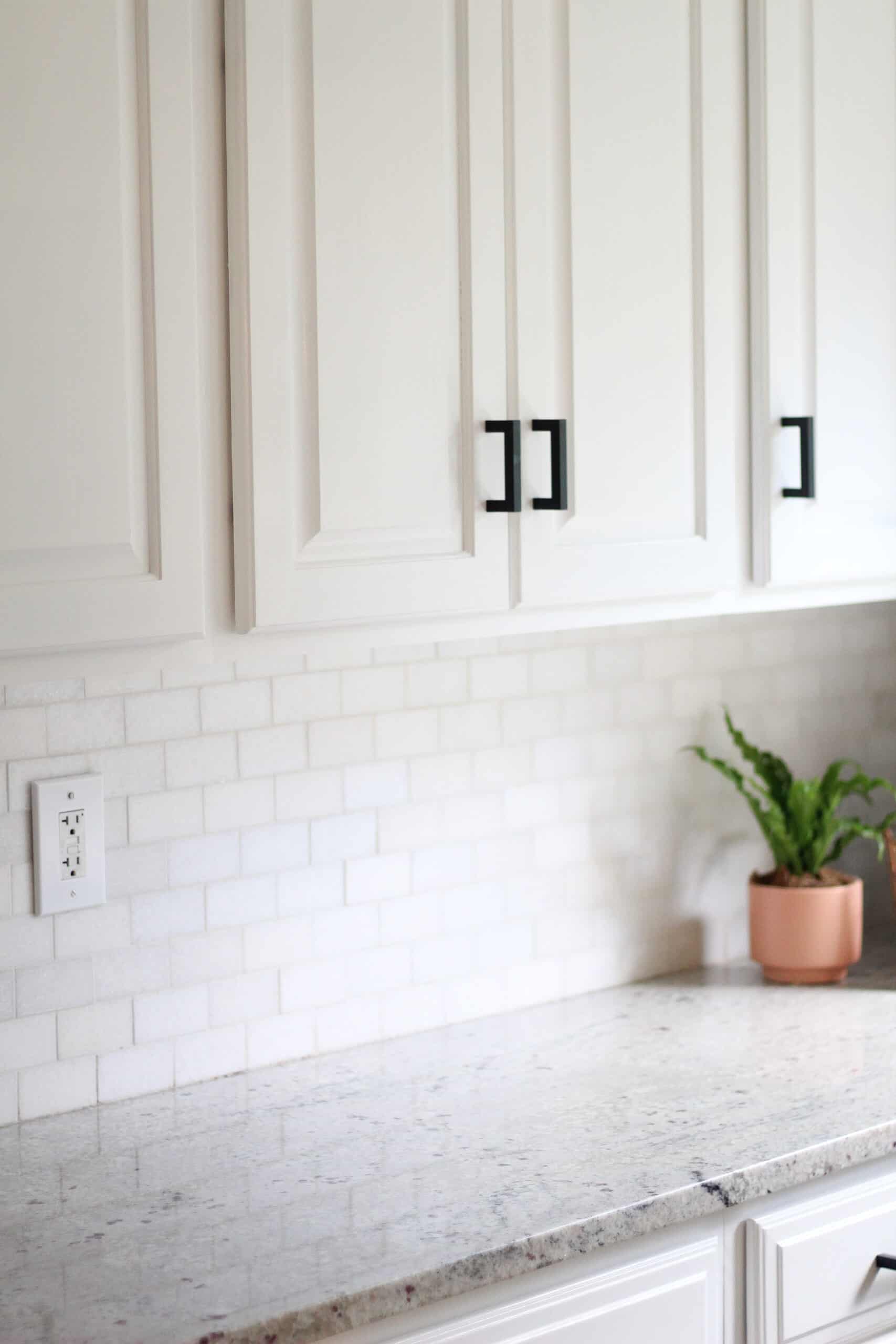 white kitchen with black cabinet pulls