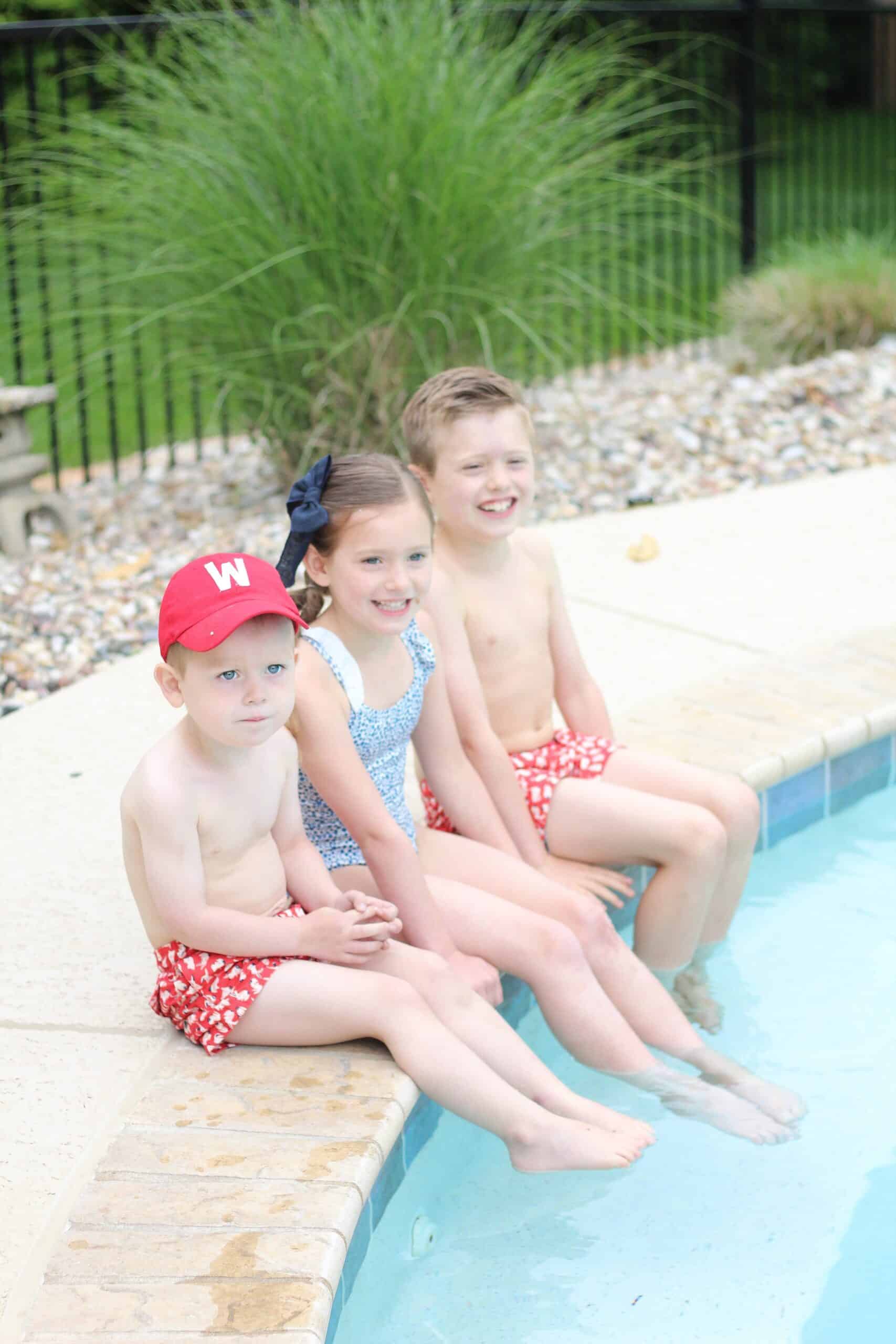 kids sitting pool side